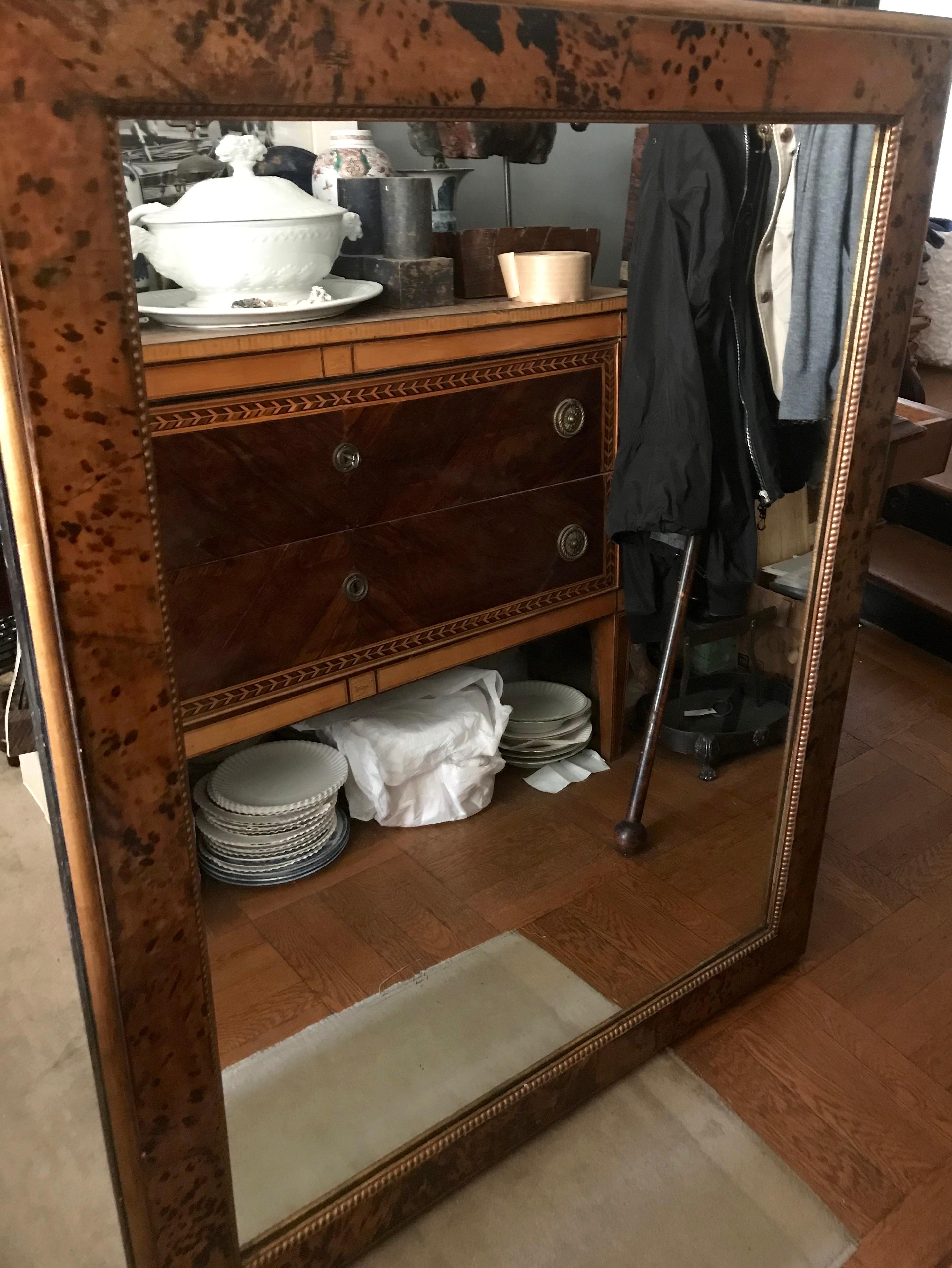 Large faux tortoiseshell mirror. Vintage Bakelite framed mirror with faux leopard print or tortoiseshell detailing with inner gold beaded banding with modern mirror plate. Italy, circa 1940.
Dimensions: 48