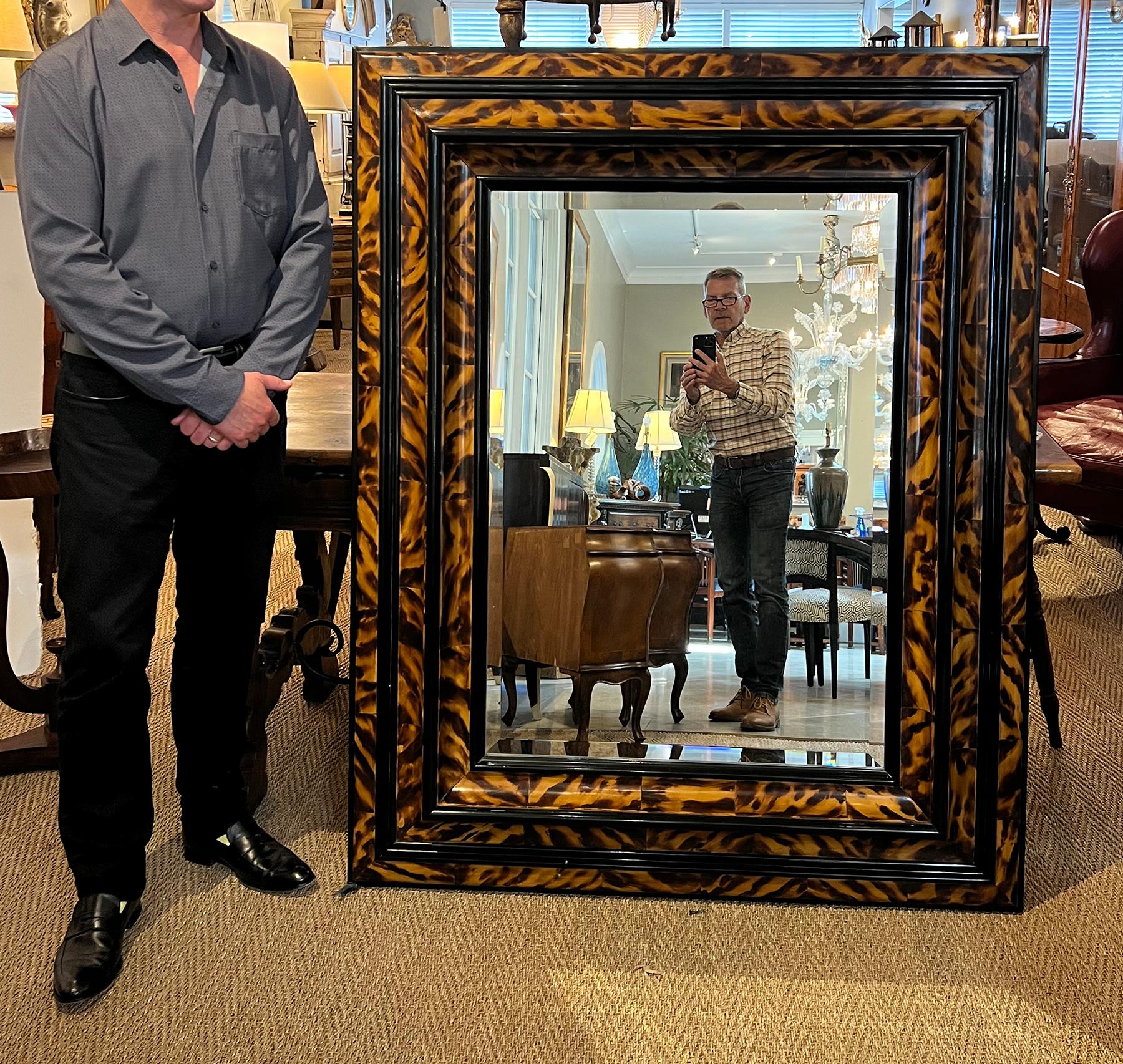 of impressive scale with stately presence, the Baroque Flemish Style cushion frame finely painted to replicate the rich, amber-like tones and distinctive radiating patterns of genuine tortoiseshell; the double-recessed frame with outer cushion