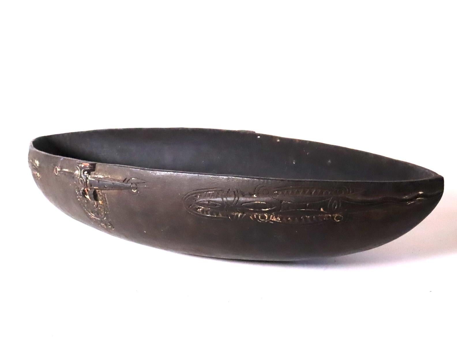 Store closing March 31. Last chance clearance sale.  Feast bowl, carved wood with black patina and remains of white lime in the incised areas. From the Massim region off the East Coast of Papua New Guinea. Probably created in the early to mid-20th