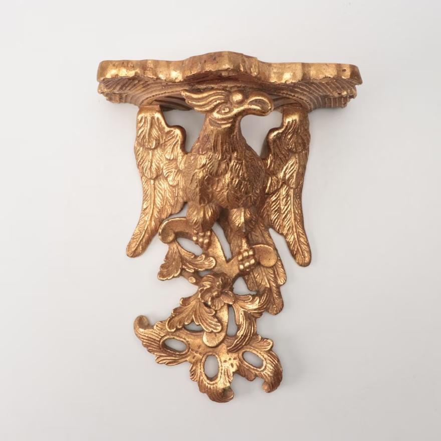 A gorgeous pair of large scale Neoclassical , Federal or Regency style gold gilt wall sconces, shelves, or brackets featuring stylized eagles and foliate designs

USA, Late-20th century

Measures: 10