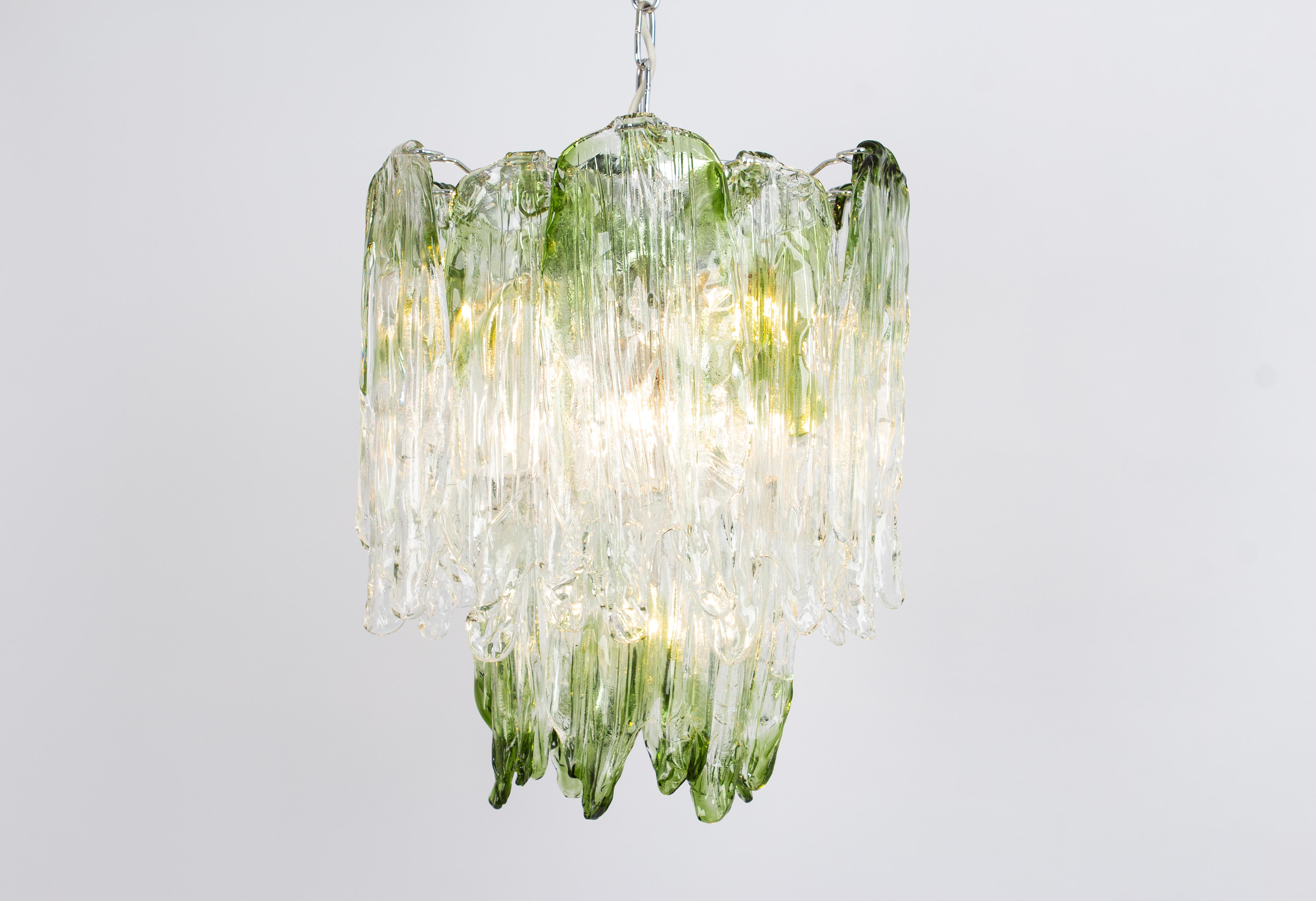 Merveilleuse suspension florale en verre clair structuré de Murano avec des inclusions vertes formant des pétales de verre, soutenue par une monture en métal. Fabriqué par Mazzega, Italie, dans les années 1970.

De grande qualité et en très bon