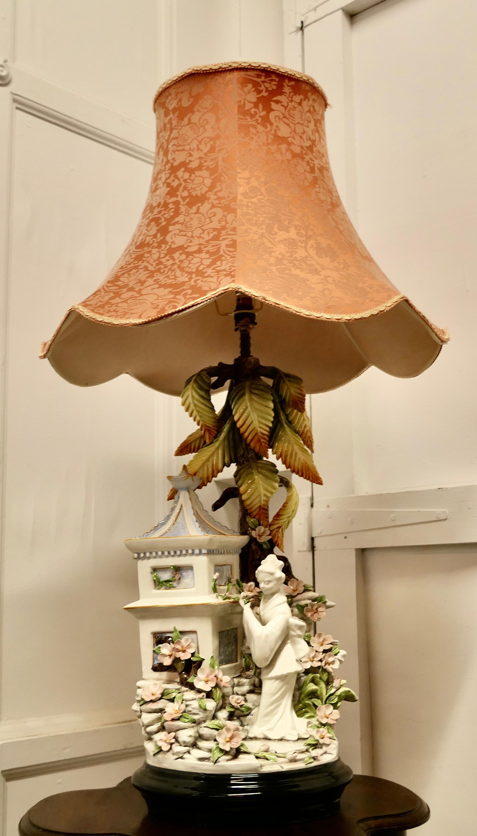 Large figural ceramic table lamp by D. Polo Uiato, Capodimonte style

This is a large and rare piece lamp, the lamp is a colourful outdoor scene with a Geisha in her flower garden under a tree next to a pagoda, the lamp comes with its original