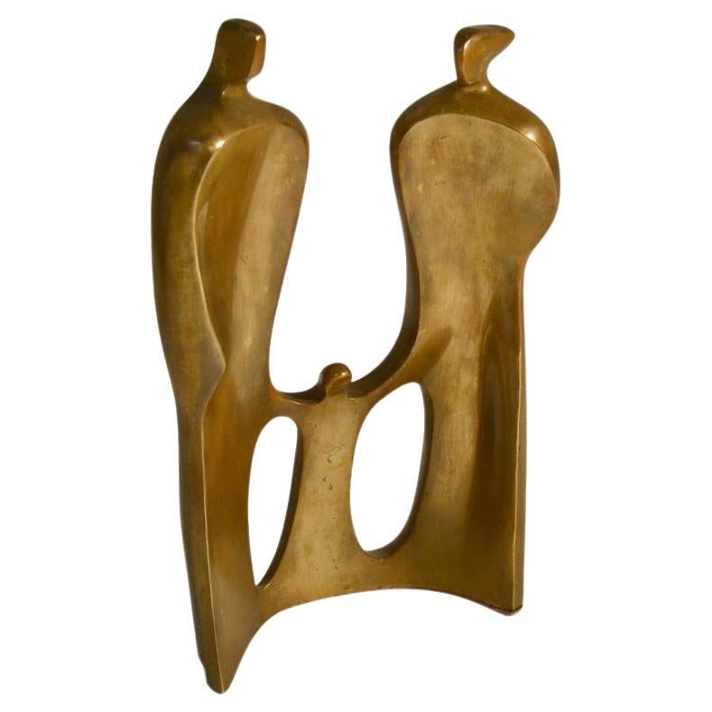 Figurative bronze sculpture of family expresses intimacy by the curved placing of the figures. The curve also created stability and enables it to stand on its own. The figures are abstracted and stylized to emphasis on the emotion it expresses. The