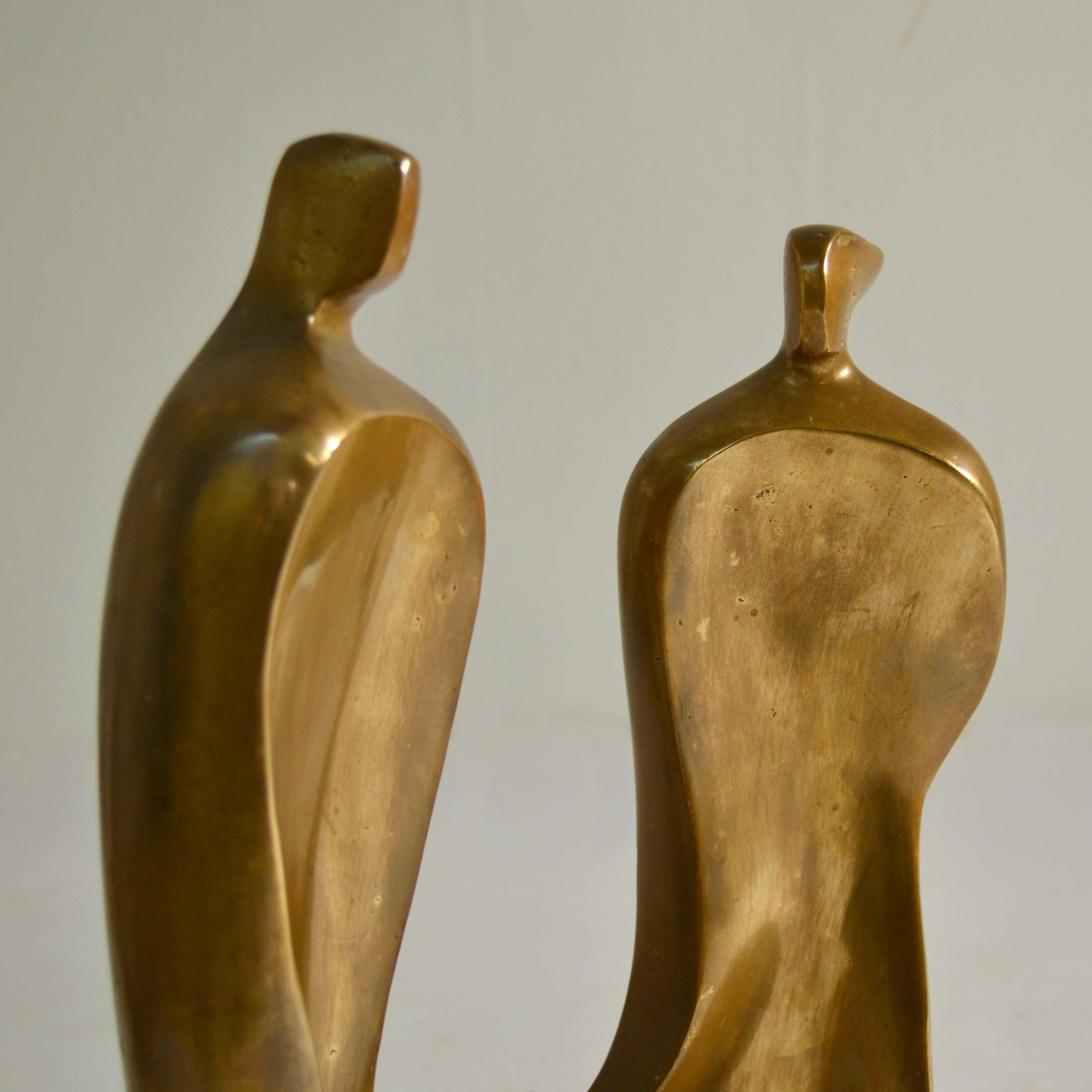 Large figurative bronze sculpture of family expresses intimacy by the curved placing of the figures by Maria Guernova (signed), 1985. The curvaceous grouping also created stability and enables the sculpture it to stand on its own. The figures are
