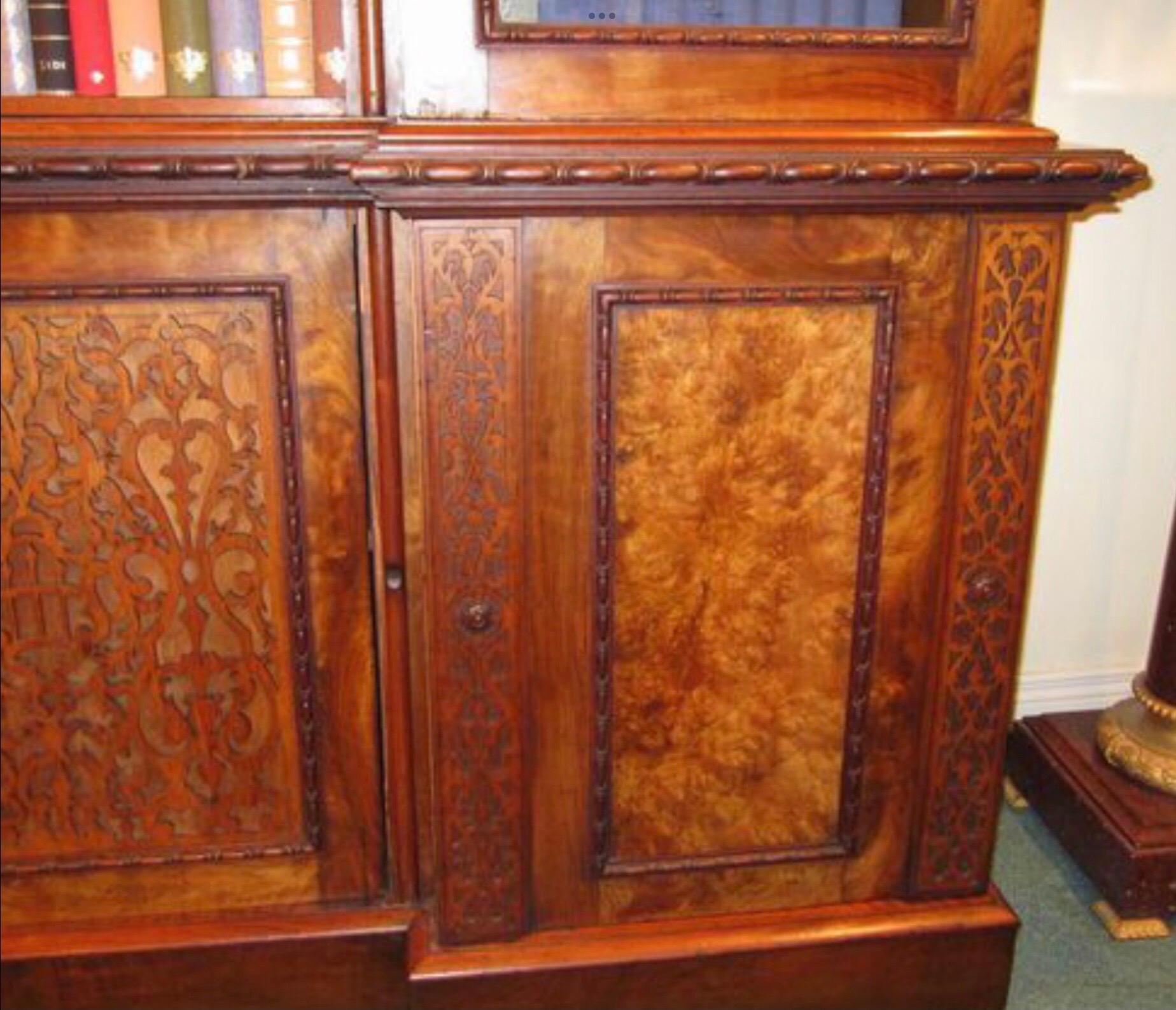 Large figured and burr walnut inverted breakfront antique bookcase
Blind fretwork and burr walnut panelled doors.
Adjustable shelves

 
Measures: 99ins high x 20.5ins deep x100ins wide.
   