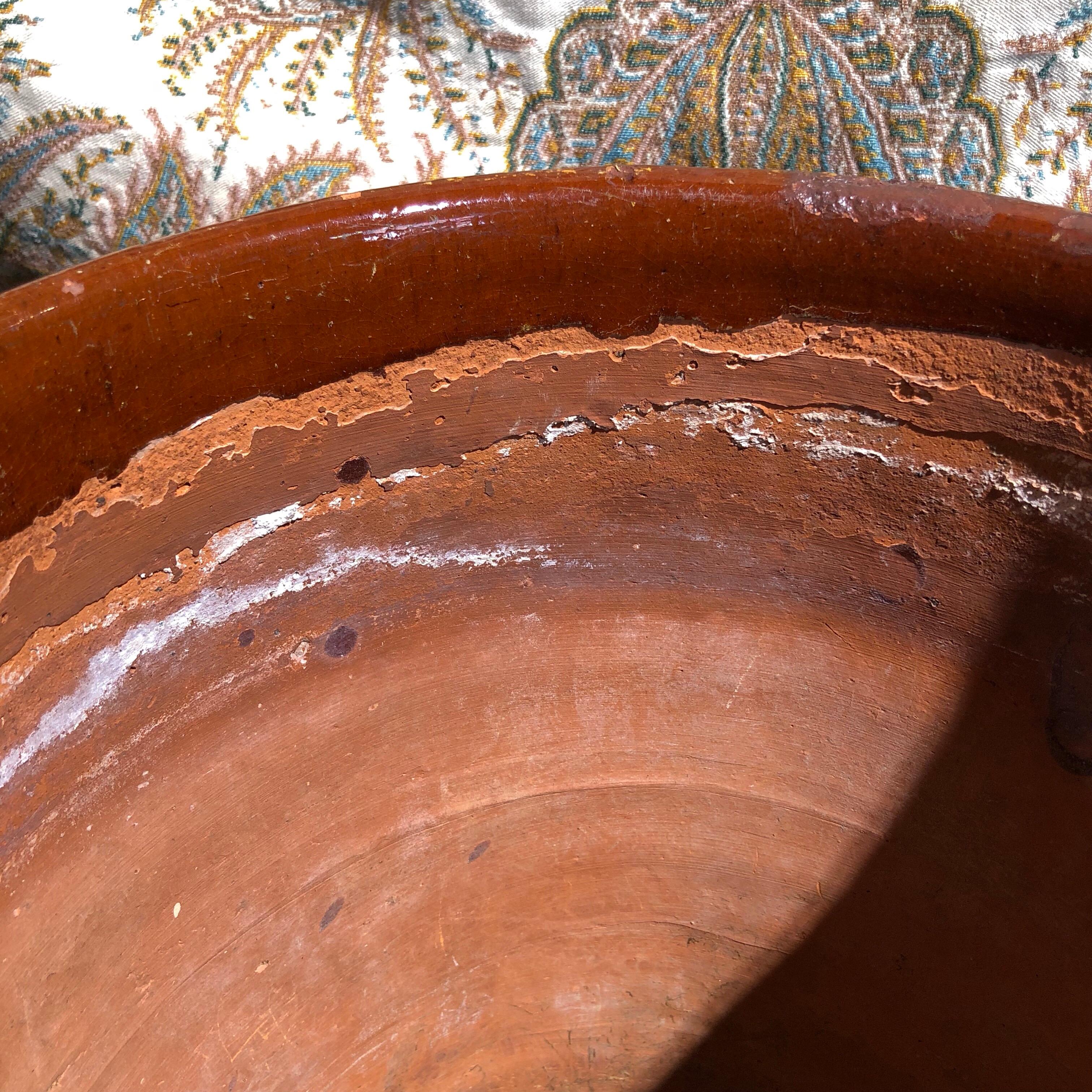 Rare large pottery plant pot, from the Philippines, molded with a bamboo plant decorated with a pale clay slip, a raised decorative ridge and dot to the upper and lower portion.
Marked to the base 'PASIG / RIZAL' and a large diamond impressed