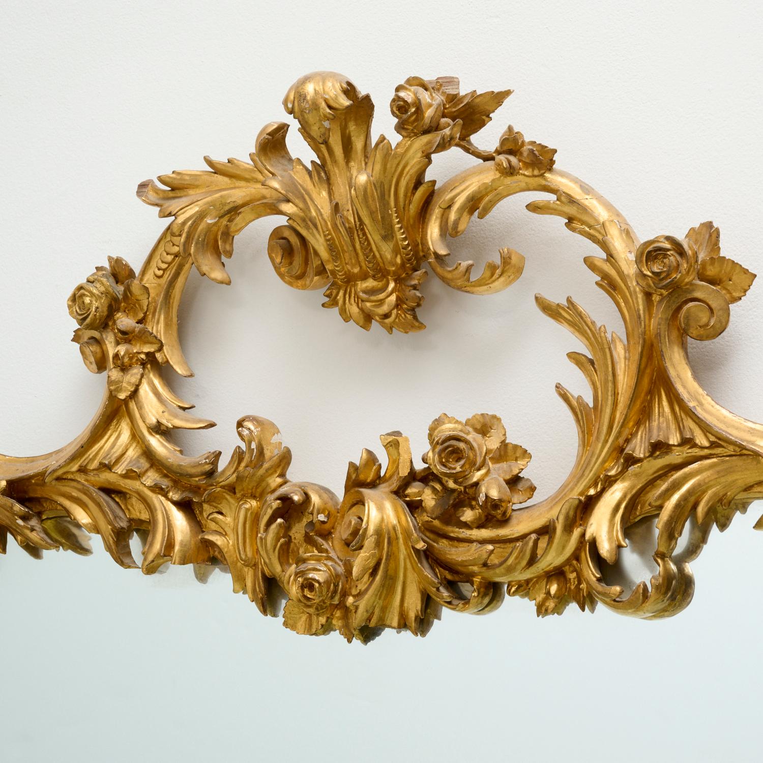 19th century, a stunning large George III giltwood pier mirror elaborately carved with an openwork top crest of floral scrolls and acanthus frond, above shaped rectangular frame carved with similar decoration, containing a single pane of mirrored