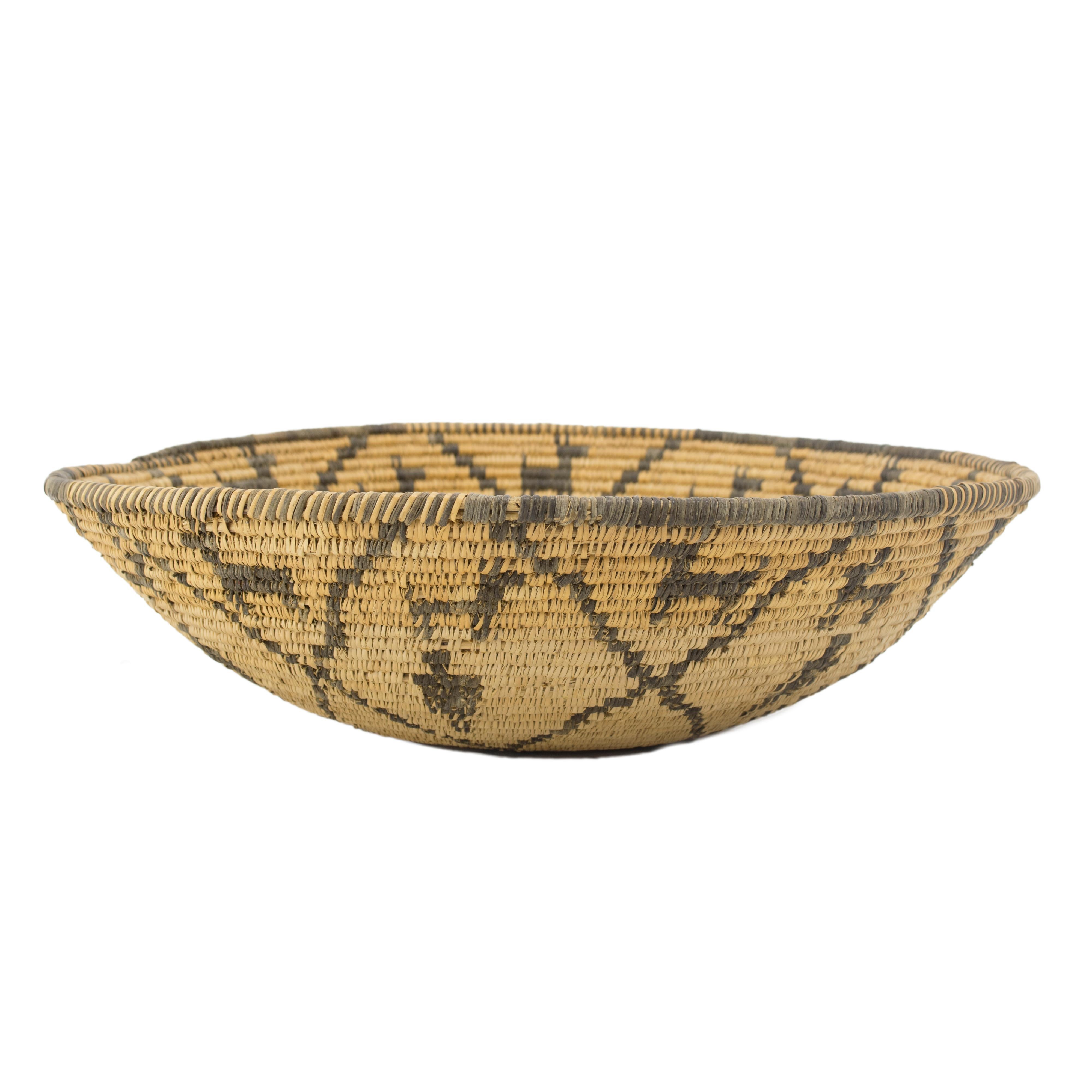 Apache pictorial bowl with dogs and man figures with center squash blossom design.

Period: First quarter 20th century

Origin: Apache

Size: 16