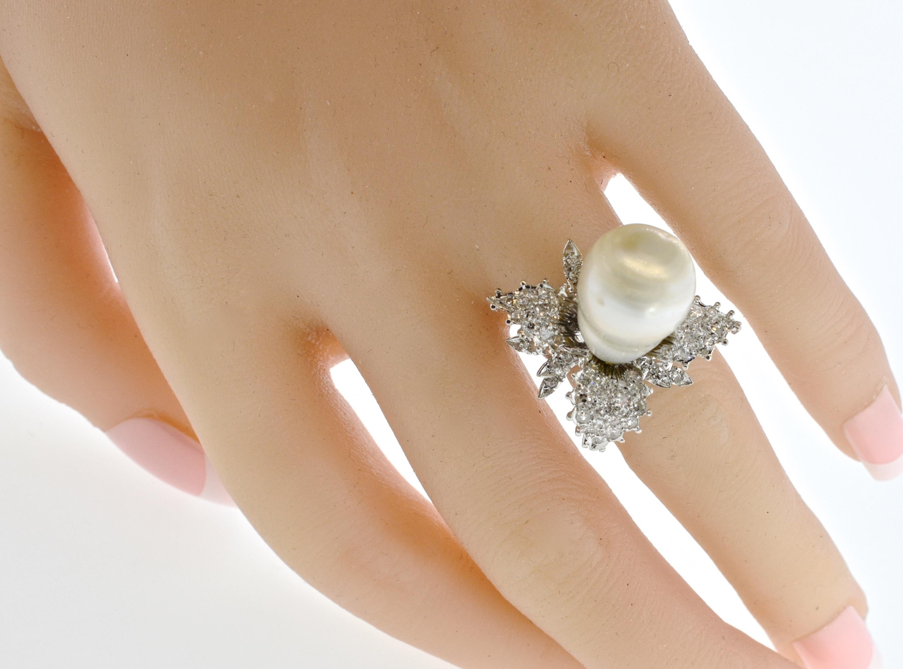 Baroque pearl - large and fine - is set in the center of leaves of  50 white diamonds, pave set in the 