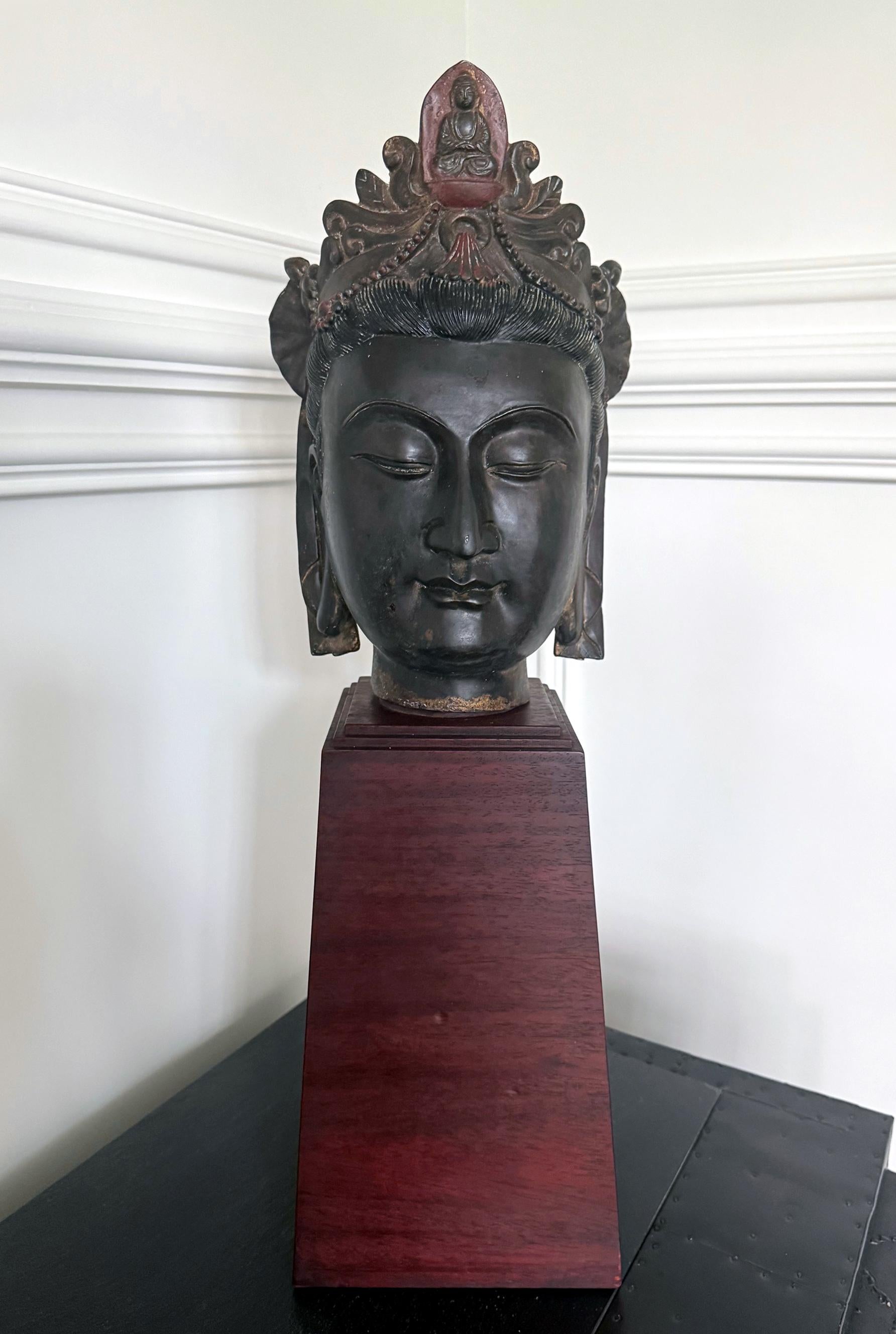 A large bronze head sculpture of Boddhisatva Guanyin from Qing Dynasty of China circa 19th century. The intact head fragment, likely belonged to a full body statue, was finely cast with intricate details. With sensitively rendered facial expression