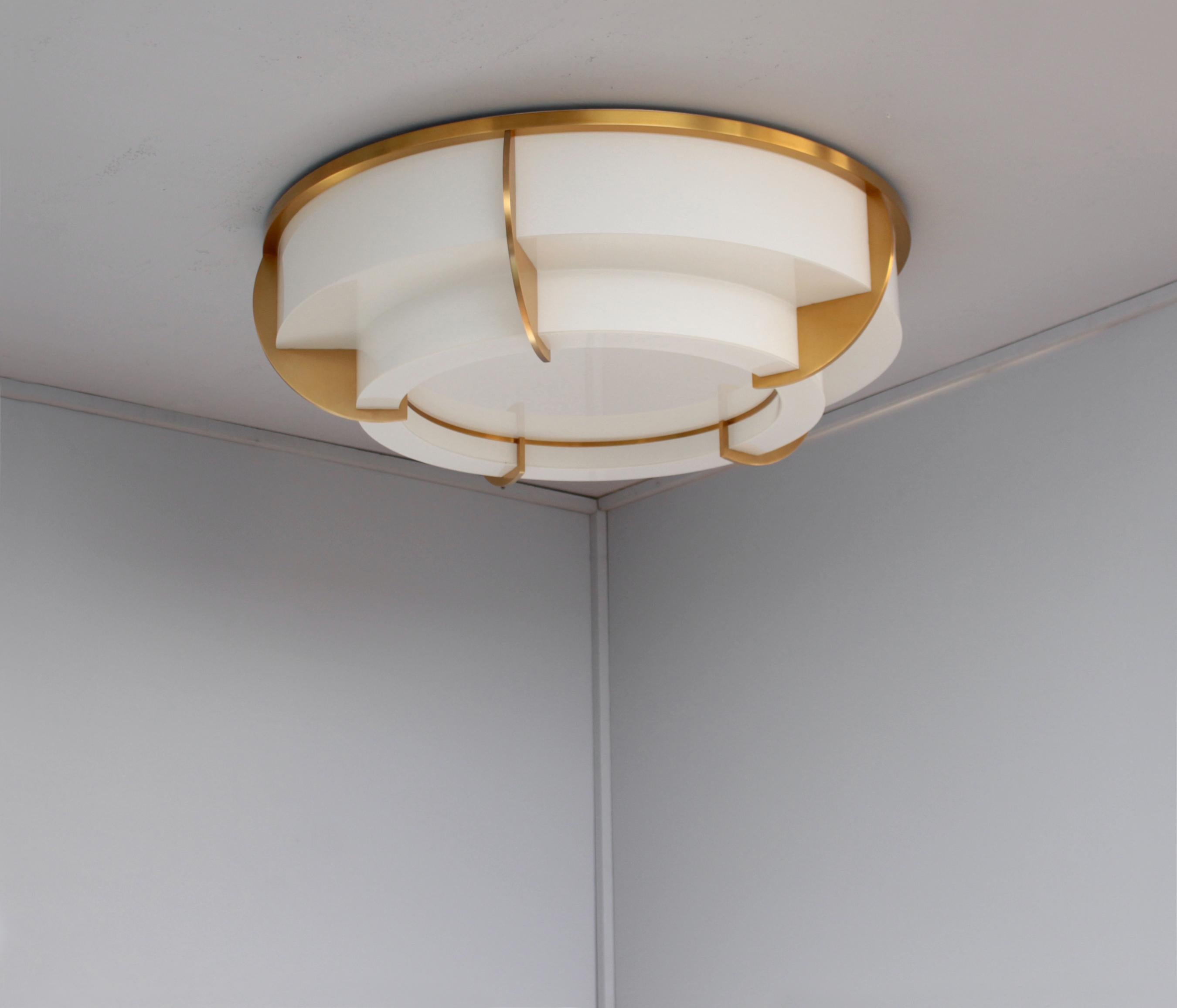 Atelier Jean Perzel - A fine French Art Deco two-tiered round ceiling fixture with a gilded lacquered crown-shaped bronze frame which supports the bent and flat enameled white glass diffusers. 
The flat bottom diffuser removes easily in order to