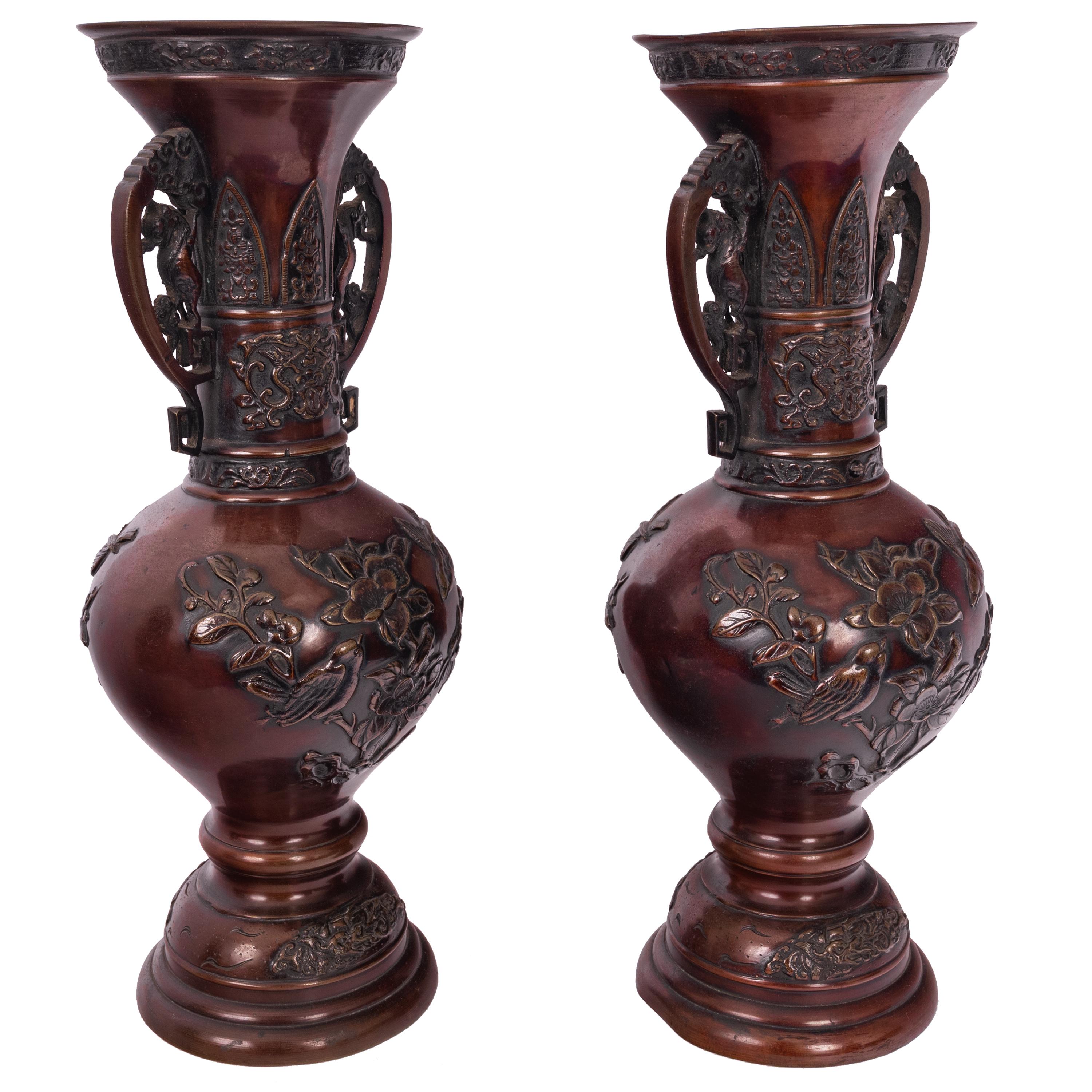 A very fine pair on antique bronze Japanese Meiji period bronze vases, circa 1890.
The vases are very finely cast and modeled in the Aesthetic taste, each vase having twin handles modeled with Japanese lions (Komainu). The flared rims with an