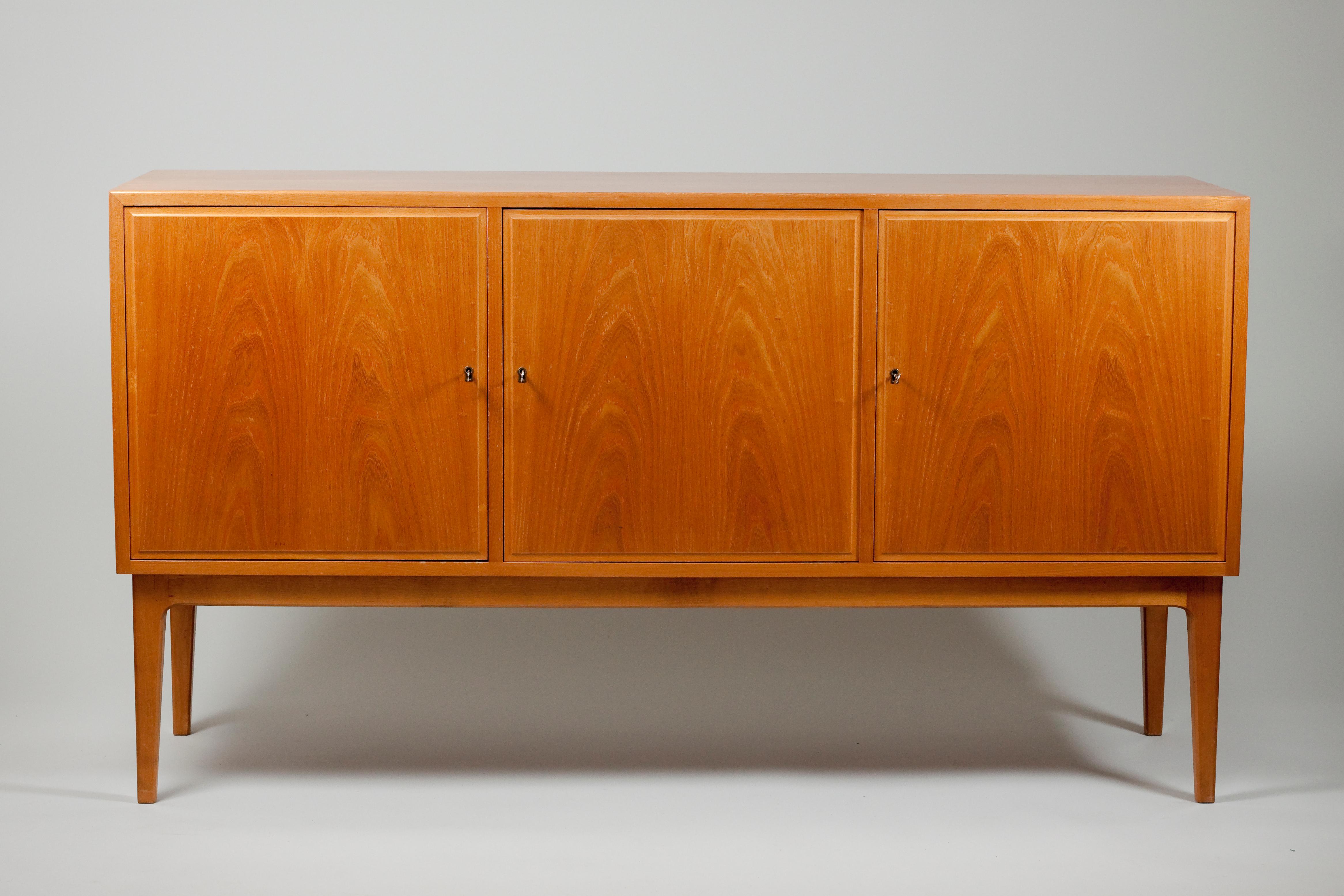 Beautiful ash large size sideboard made in Finland in the 1950s. The sideboard is well made and even the inside of the doors are laminated in the finest ash veneer. The inside is clean and in mint condition. Inside the sideboard there are two