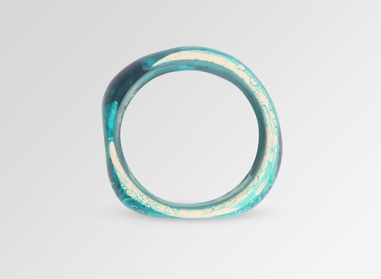 Resin organically shaped bangle. This bangle is featured in our Classic colour, Lagoon. 

Dinosaur Designs resin products are hand made in Sydney, Australia. Each piece is unique and we cannot guarantee you will receive an item exactly identical to