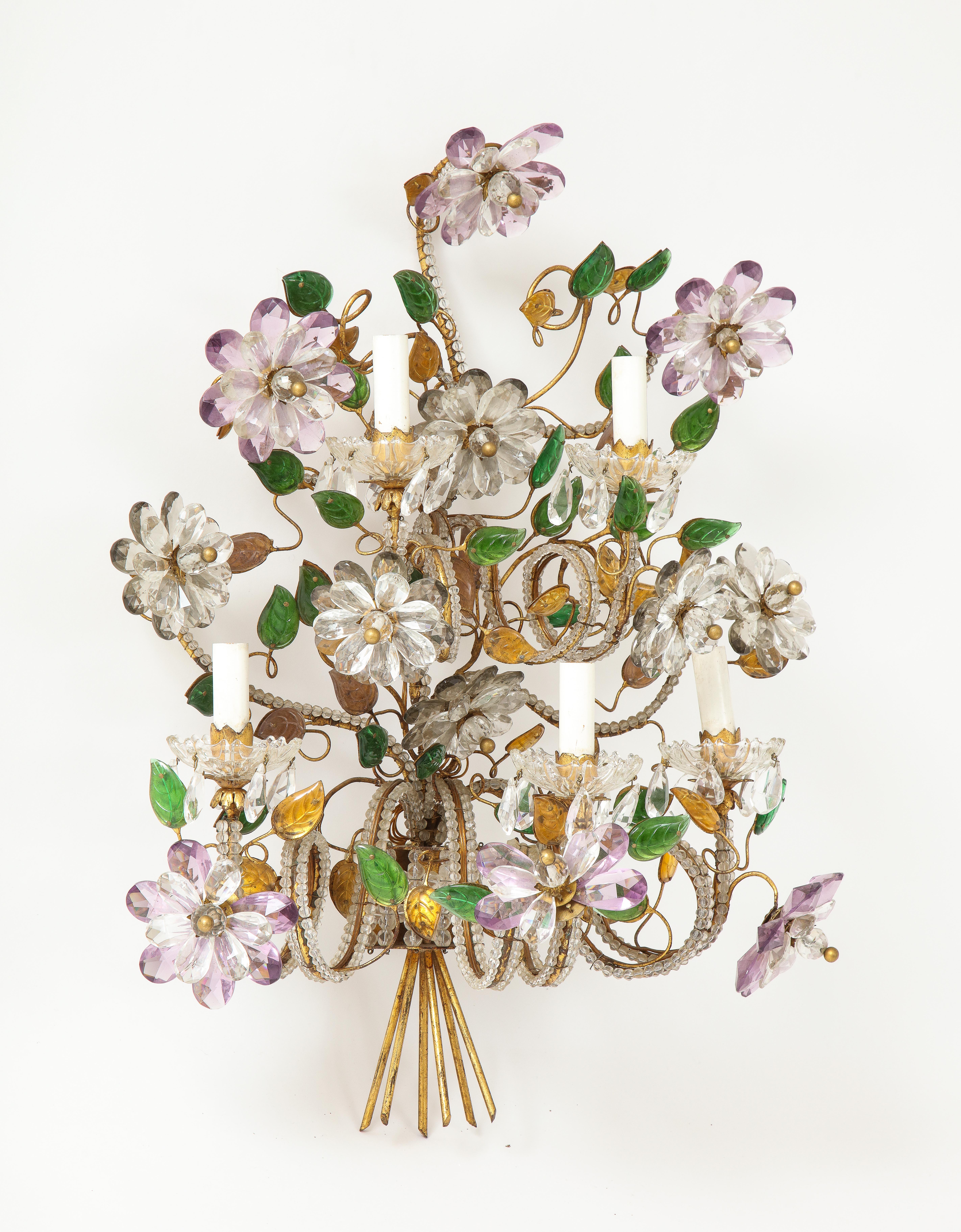 A wonderful large five arm Bagues sconce with colored glass details flowers and leaves supported by bronze frame lined by crystal beads.