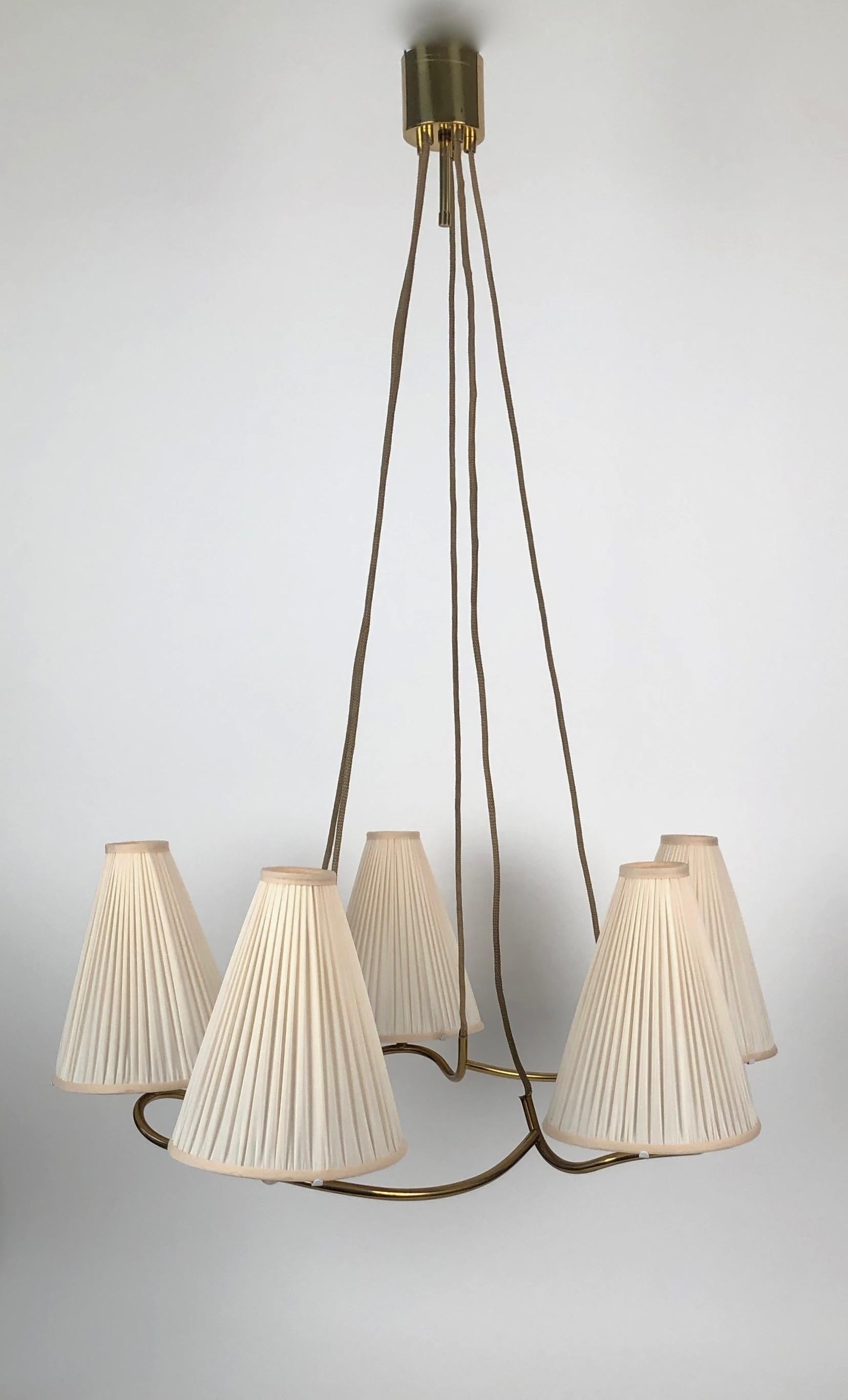 A rare J. T. Kalmar Heron suspension chandelier ( model 3639 ) from the 1930's.
The brass frame has a sculptured form that supports five conical shades, that have
been recovered with silk, using the original frames.

The electric has been controlled