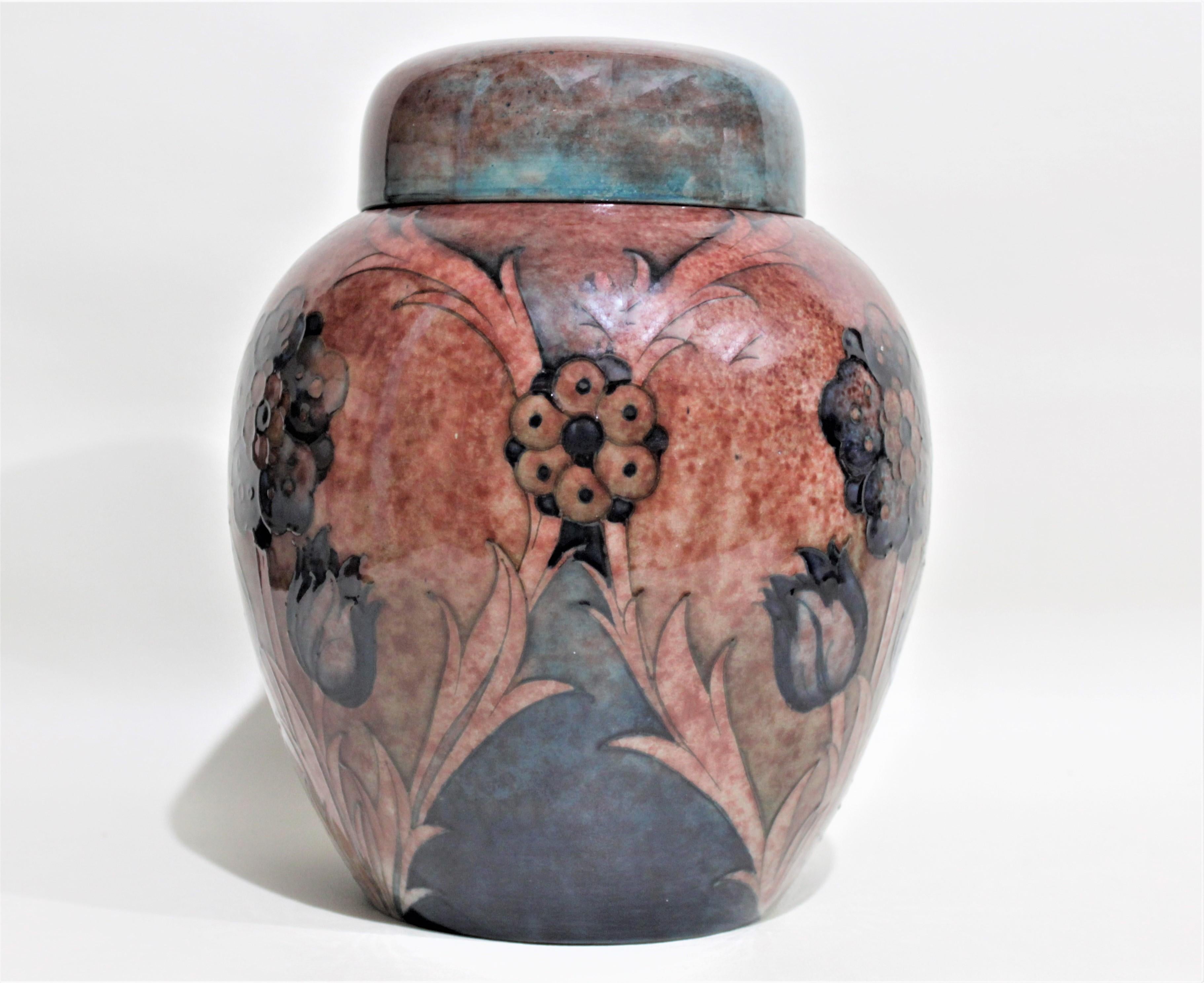 This large and substantial art pottery ginger jar was made by the Moorcroft Pottery company of England, in the period and style of the Art Deco era. The pattern presented on this ginger jar is unknown, but features a series of dark cobalt blue