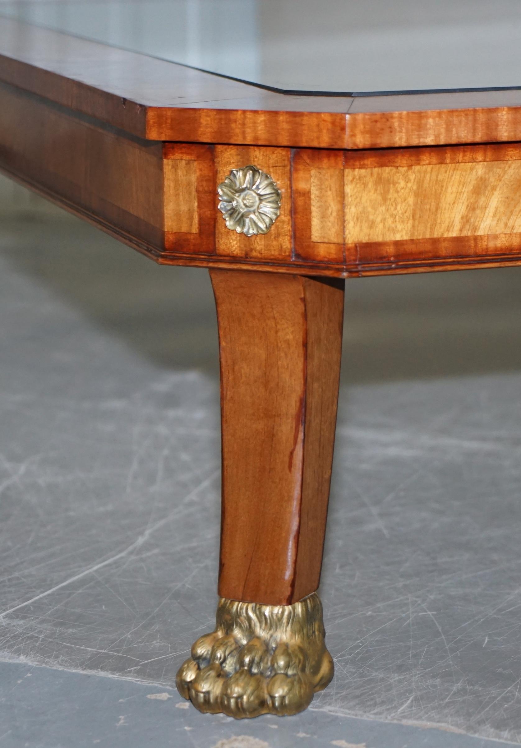 We are delighted to offer for sale this very large flamed mahogany coffee or cocktail table with gilt bronze Lion's Hairy Paw feet

A very nicely made table, its extremely high quality, the glass top is bevelled safety glass, the feet are gold