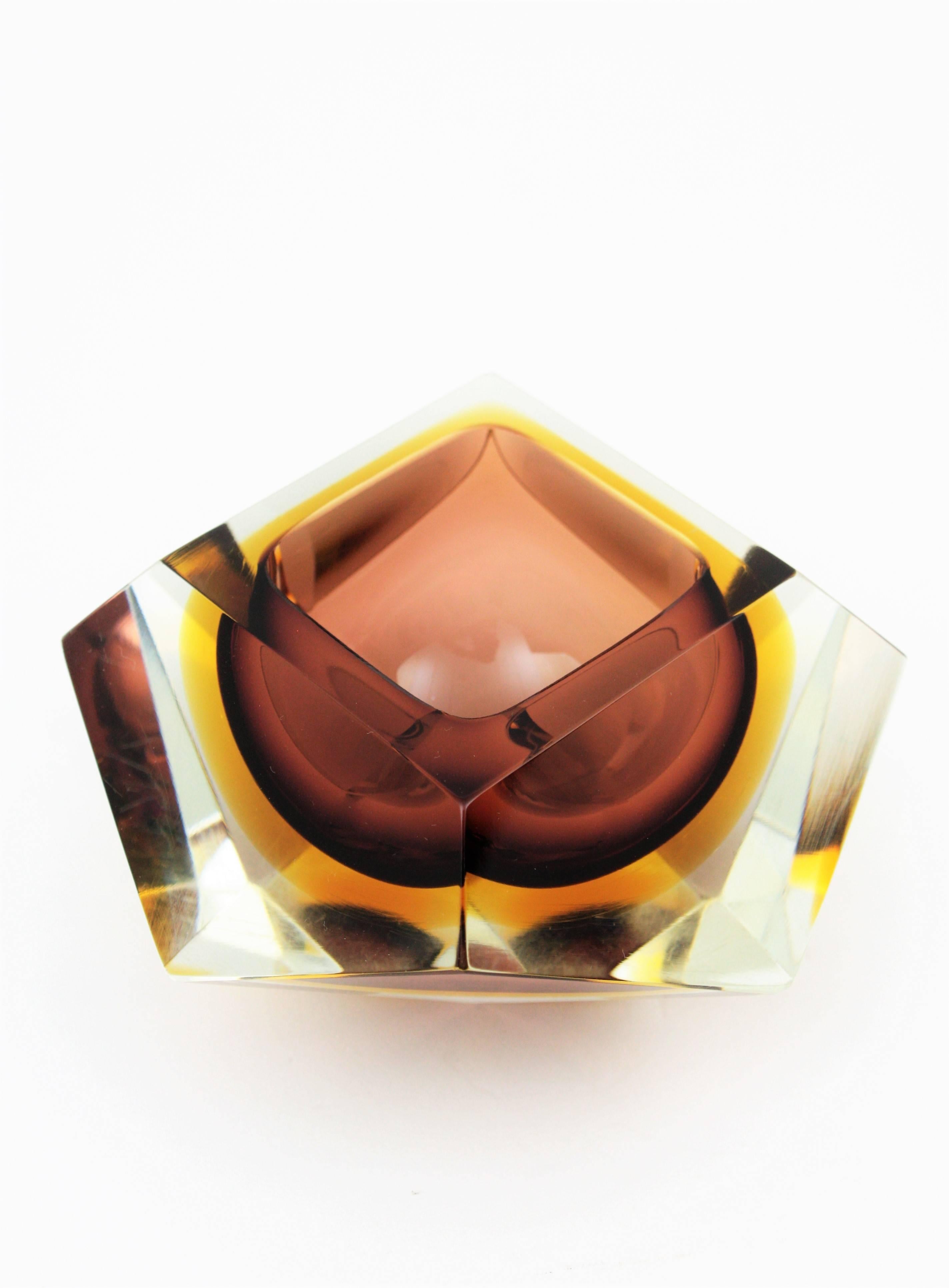 A beautiful brown and yellow Sommerso faceted Murano glass bowl attributed to Flavio Poli. Italy, 1950s.
Brown and amber glass cased into clear glass and a highly decorative twelve faced geometric design.
Useful as bowl, ashtray, jewelry bowl or
