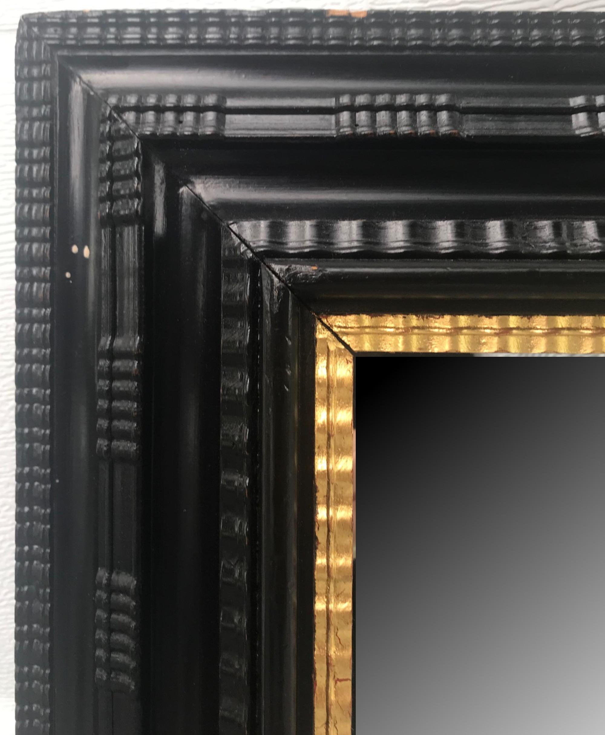 Large Flemish ebonized Ripple frame mirror with gilded liner, circa 1900

This is a Classic Flemish ebonized ripple frame mirror with a gold leaf liner. The depth and detail is exceptional. The molding is highlighted by a ripple panel pattern with