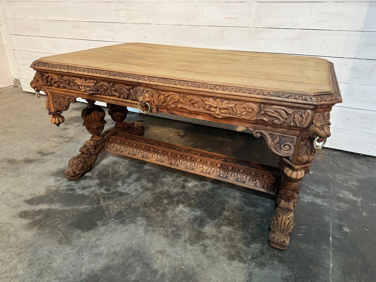 A beautiful Flemish Dolphin Centre Table in a larger size than normal. Made from solid Oak in the last quarter of the 19th Century. We have bleached it for a lighter look. Beautifully carved with lions mask handles to the 2 drawers and the famous