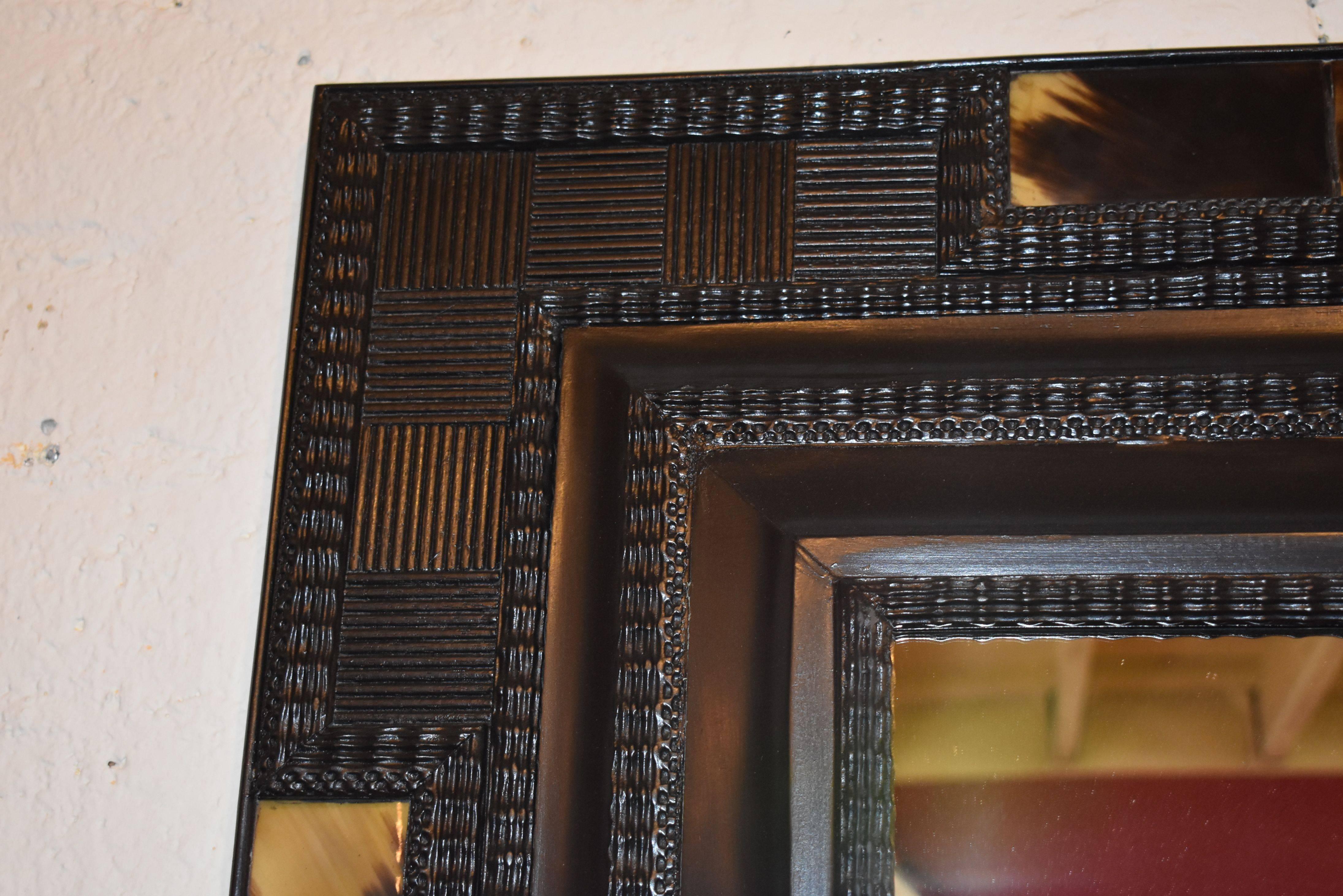 Ebonized frame cover with horn mirror.