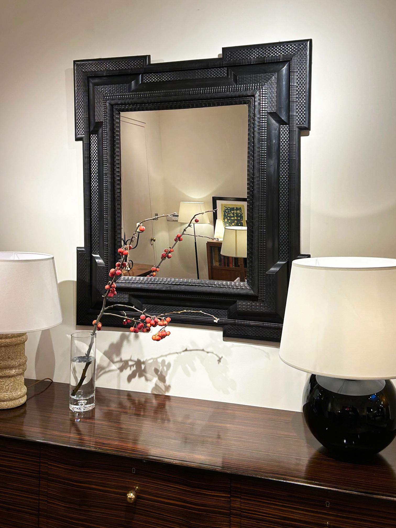 A large Flemish style ripple frame mirror, with geometric 'ears'.
Italy, Circa 1880-1920
New mirror glass
