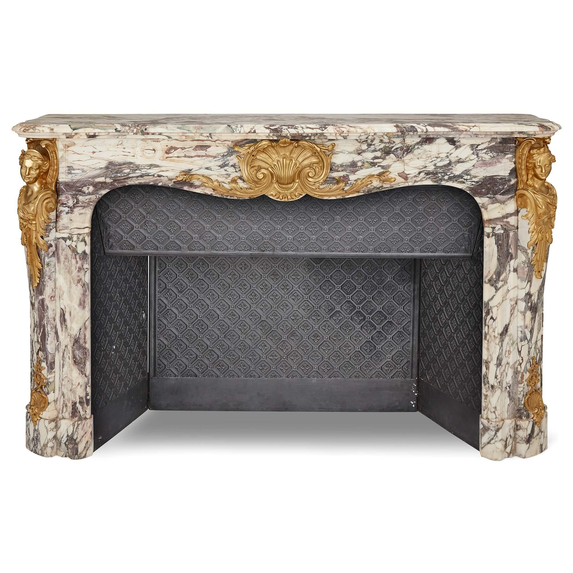 Large Fleur de Pêche marble and ormolu antique fireplace
French, 19th Century 
Height 121cm, width 188cm, depth 63cm

This stunning fireplace combines unusual Fleur de Pêche marble with sculptural ormolu mounts. The fireplace consists of a panelled