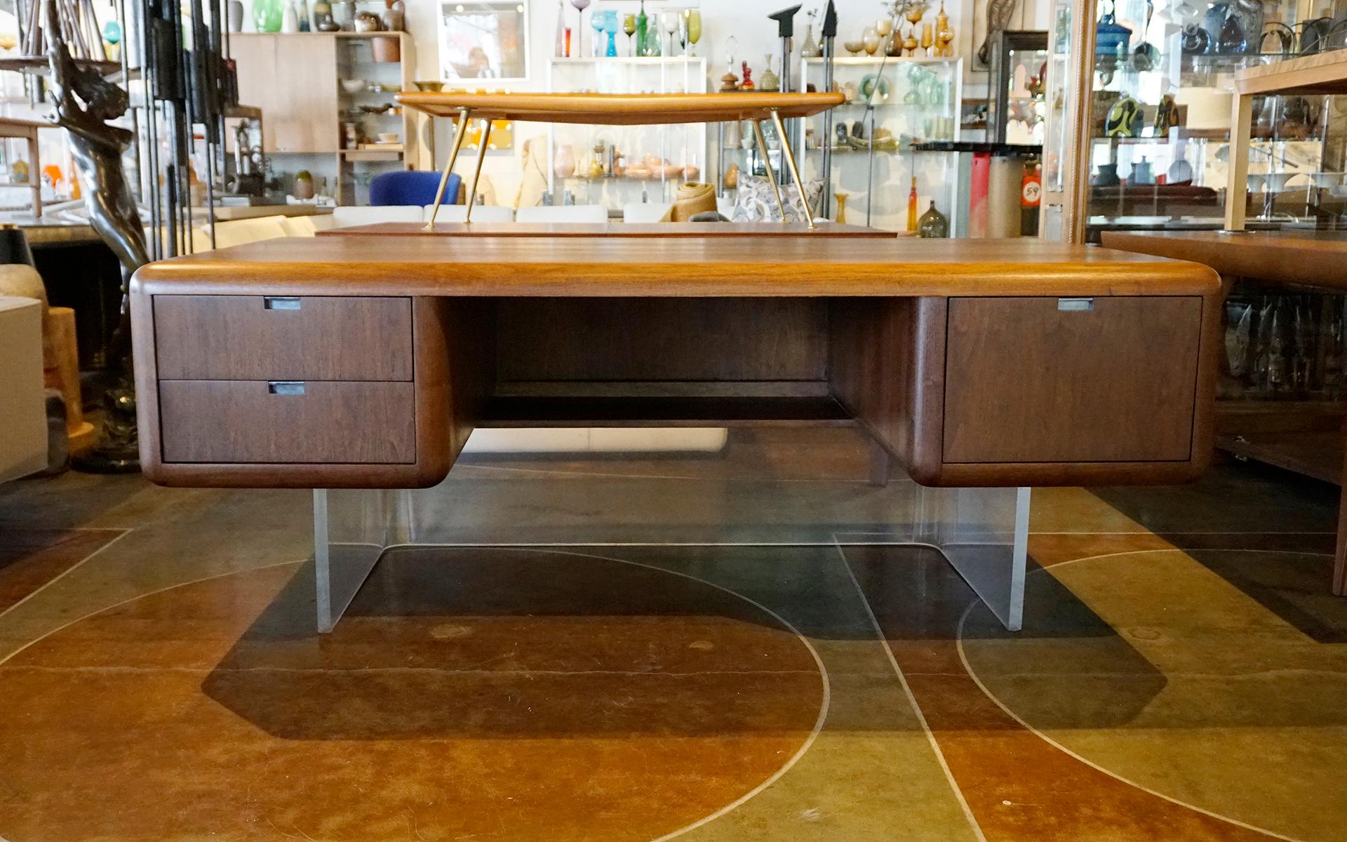 Amazingly cool, mid century modern desk.  Rectangular form with rounded corners.  Heavyweight construction floating on a super sturdy one inch thick acrylic base.  Expertly restored and refinished.  We also have the matching credenza