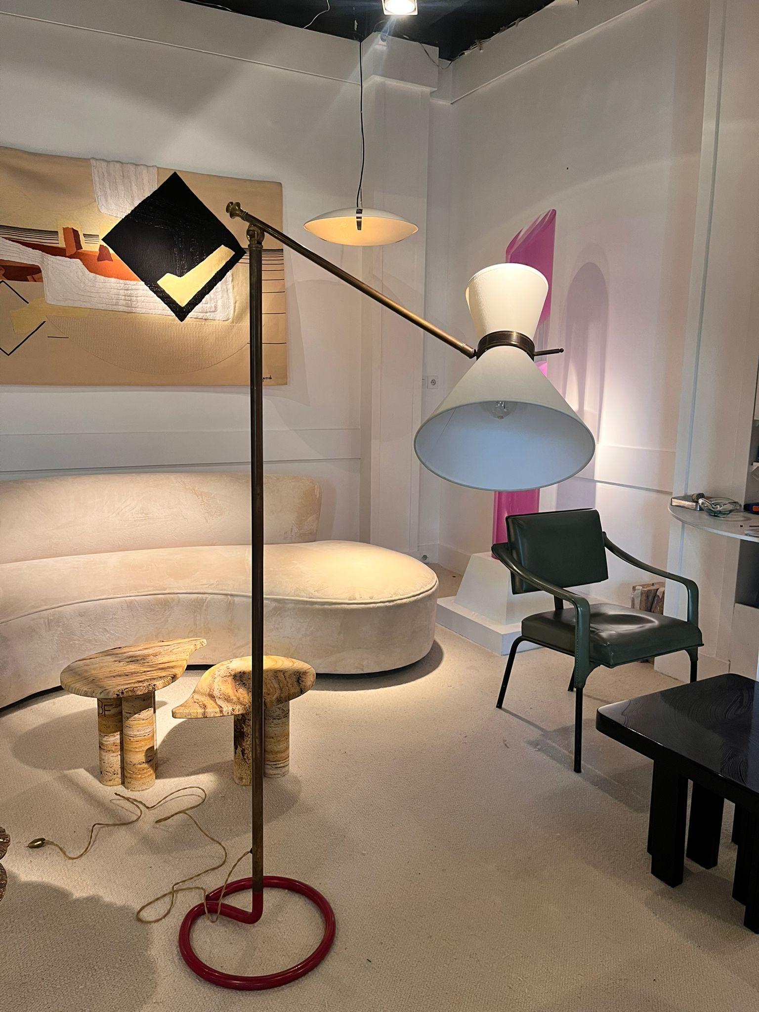 Large Floor Lamp by Stablet, France, circa 1930–1950

Published by Stablet. Rare floor lamp features a bent arm with an adjustable head, a double diabolo lampshade, and a brass metal shaft. Circular base in red lacquered steel.

Signed with the