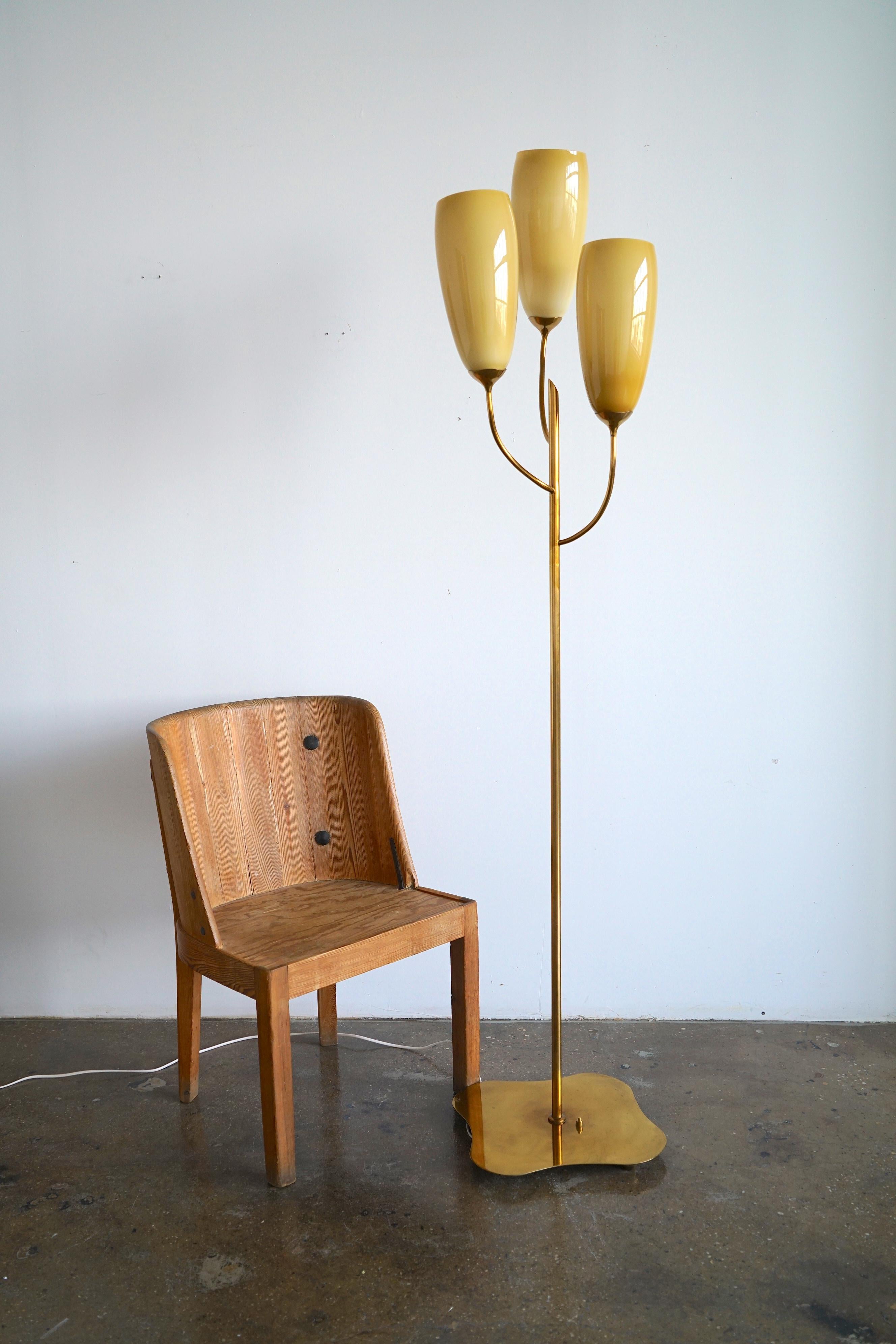 Tall floor lamp produced by Taito Oy, Finland , Circa 1940th.
Custom order, design attributed to Paavo Tynell.
Polished brass with (3) opaline glass shades on free form brass base.
The lamp has existing European candelabra sockets. Dimensions : H