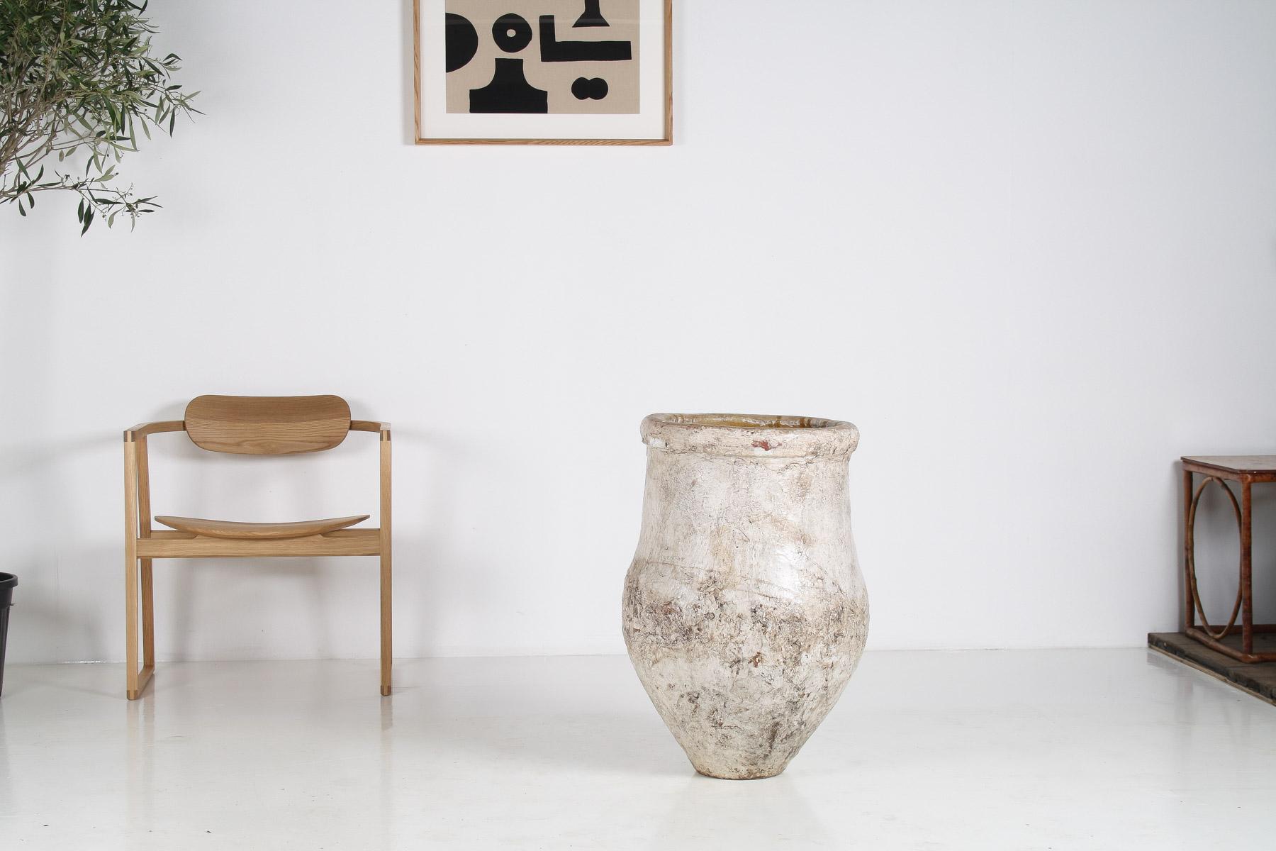 A large floor standing Amphora Planter with weathered patina.
A 20th Century piece, terracotta with a white wash finish that has aged to a characterful patina.
Nice elegant form, with narrow base and a beautiful curvature, thick rolled rim with a