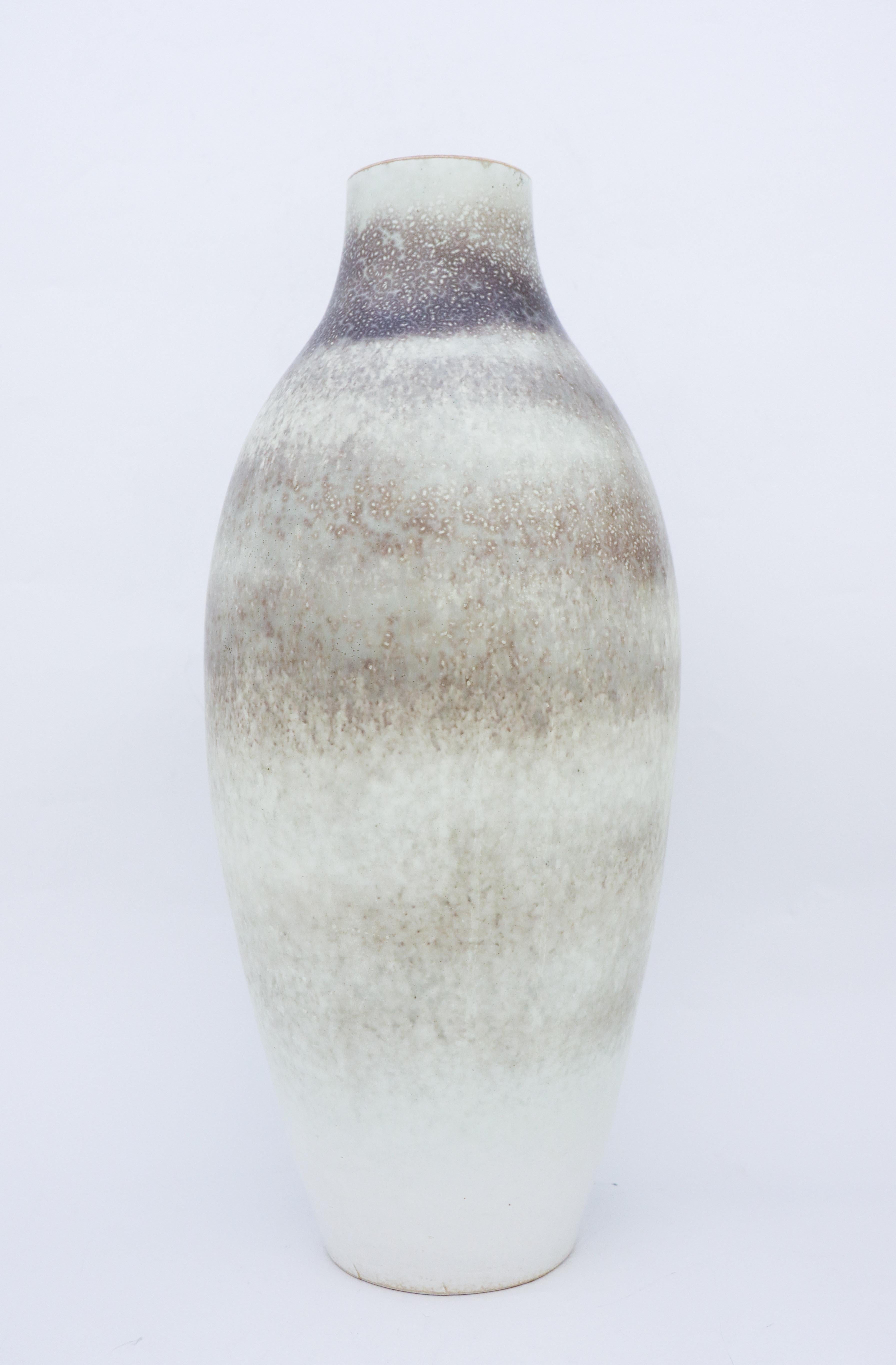 A Large vase by Carl-Harry Stålhane with a beautiful grey speckled glaze. It is made in the 1950s. The vase is marked as 2nd quality because of the small cracks in the ceramics at the base, it also have two minor brown marks in the glaze. Except