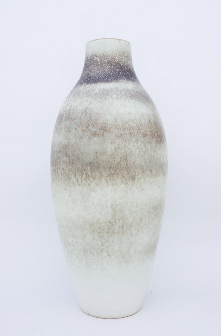 A Large vase by Carl-Harry Stålhane with a beautiful grey speckled glaze. It is made in the 1950s. The vase is marked as 2nd quality because of the small cracks in the ceramics at the base, it also have two minor brown marks in the glaze. Except