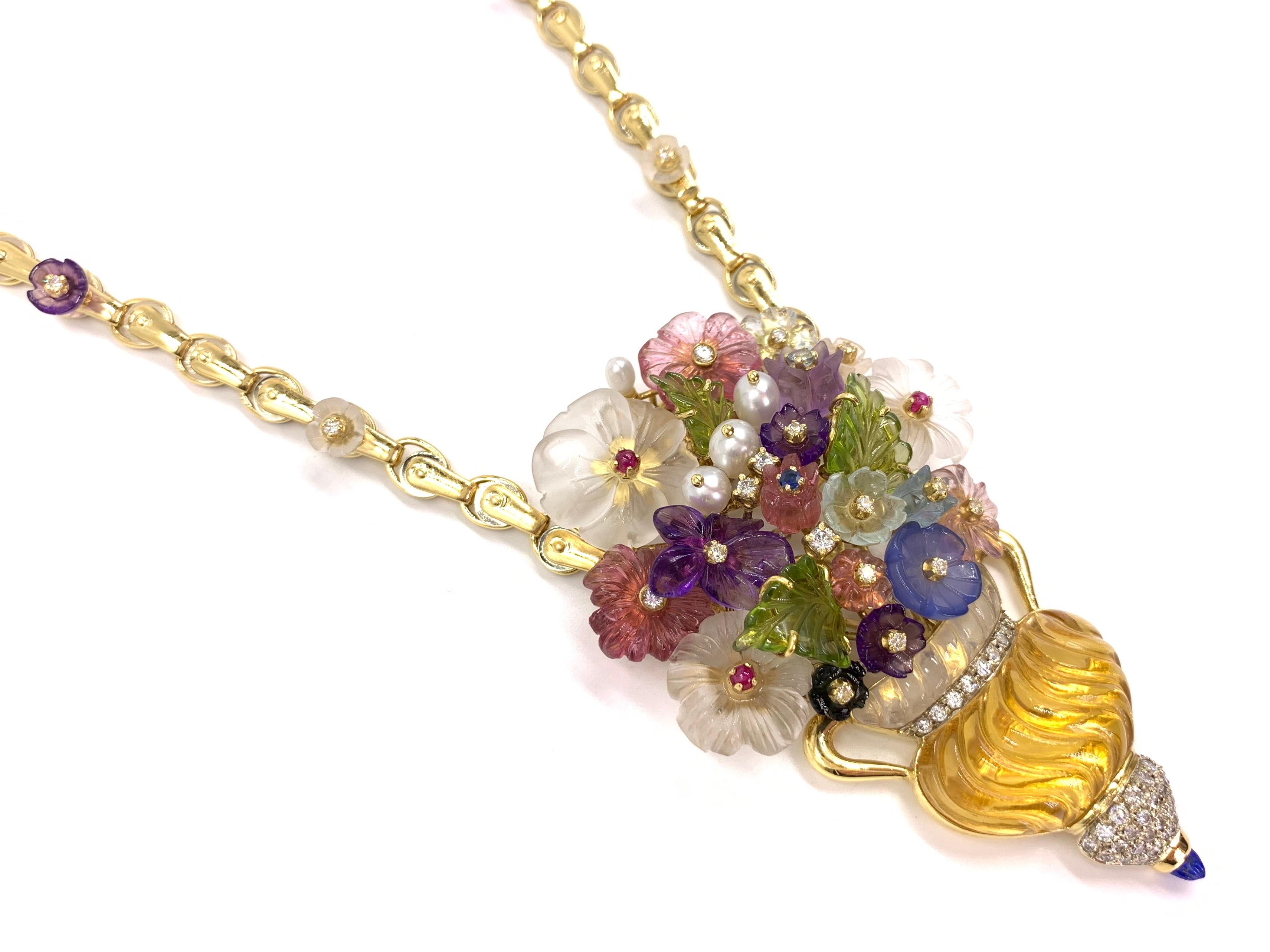 Circa 1980 from the exclusive and unique Italian jewelry designer Santagostino, known for their artistic jewelry which can hold up to twenty different types of faceted and carved gemstones. This fascinating hand made pendant floral motif necklace is