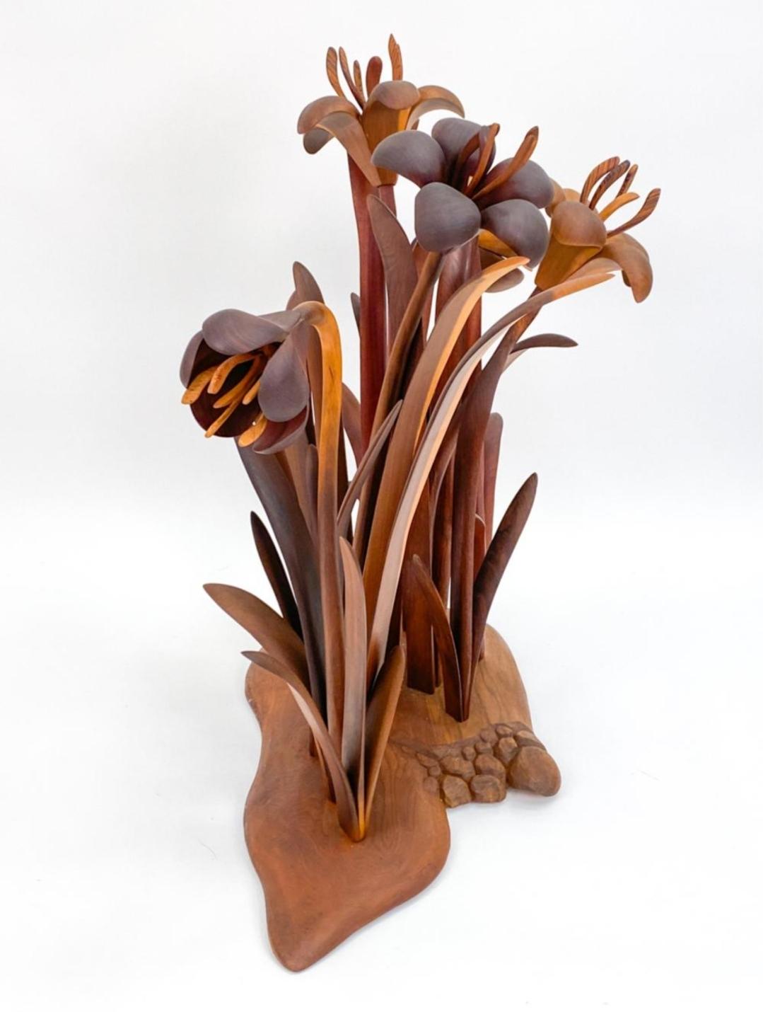 A gorgeous hand carved sculpture in walnut and cherry by the American artist team of Jeffrey and Lindley Briggs. Created in 1982 in their New England studio. This piece is made from multiple carved wood elements that had been intricately placed