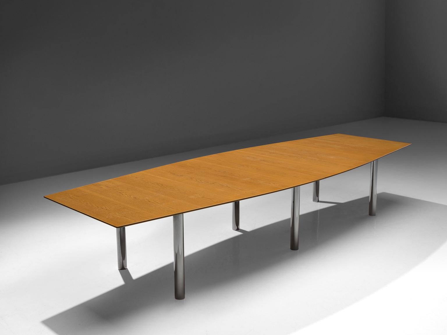 Florence Knoll for Florence Knoll International, large dining table, walnut, metal, United States, 1963.

Large dining or conference table with boat shaped top in walnut. The table has six cylindrical metal legs. The top of this table shows the