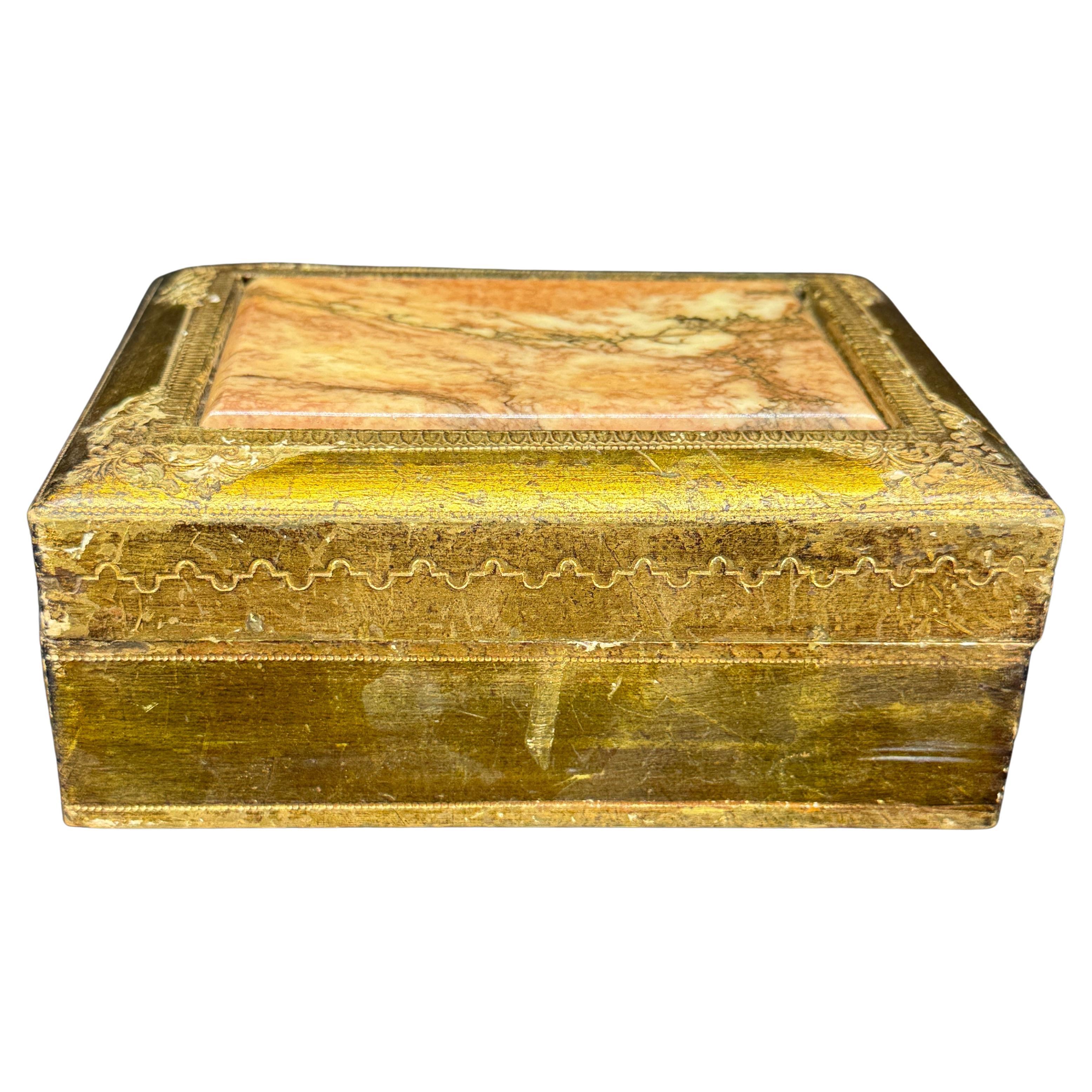 Exquisite Italian Florentine Box. This 1960's box features a marble top on the lid. This rectangular box could be used for storage or jewelry and would certainly make a statement on a coffee table. Great piece to add to a collection of these sought