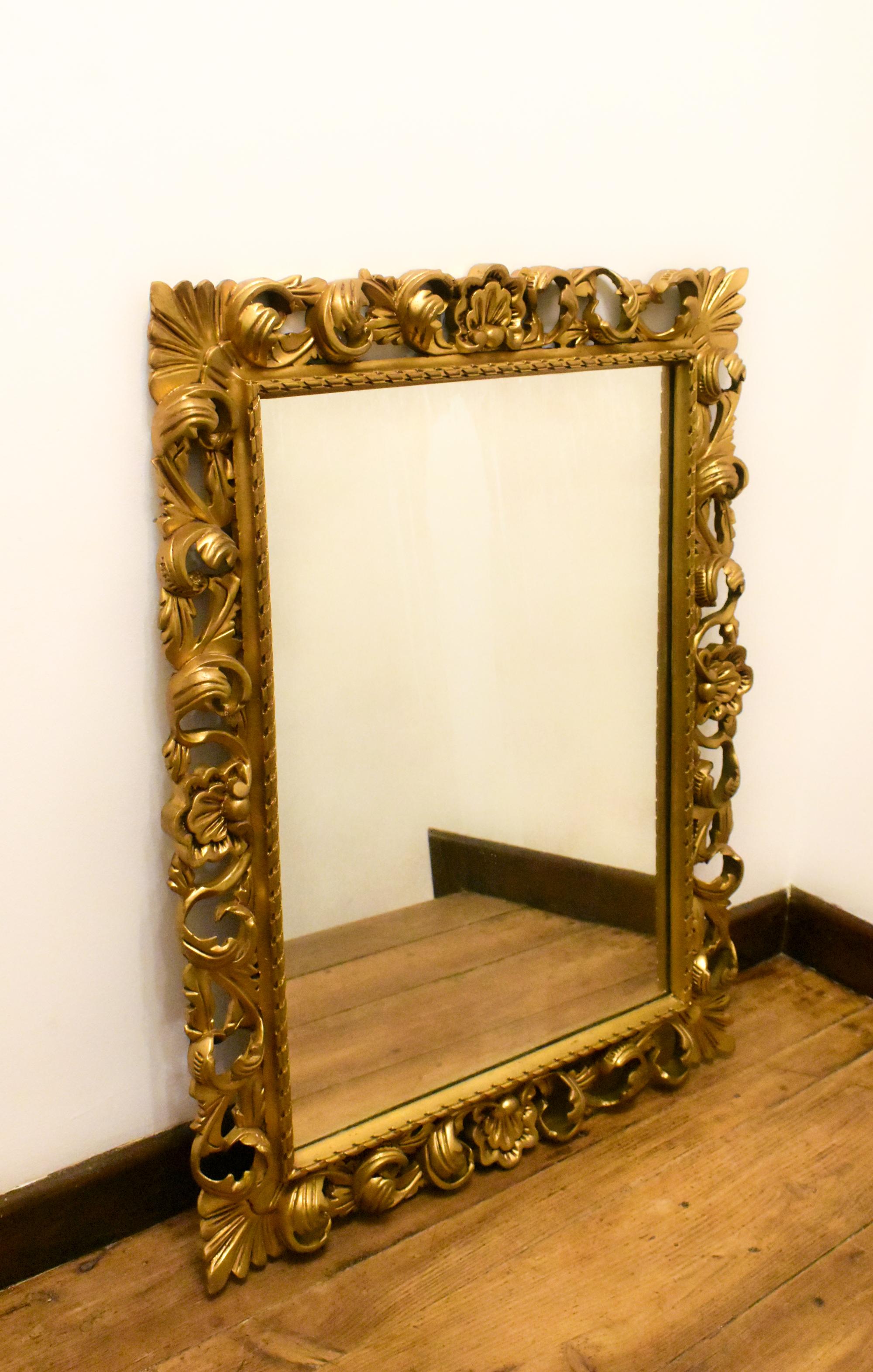 Large Florentine Style Giltwood Wall Mirror 

This beautifully carved gilt mirror features large floral leaves and shells surrounding a moulded rope inner frame. 

To the rear are hanging hooks for landscape or portrait hanging modes. 

The ornate
