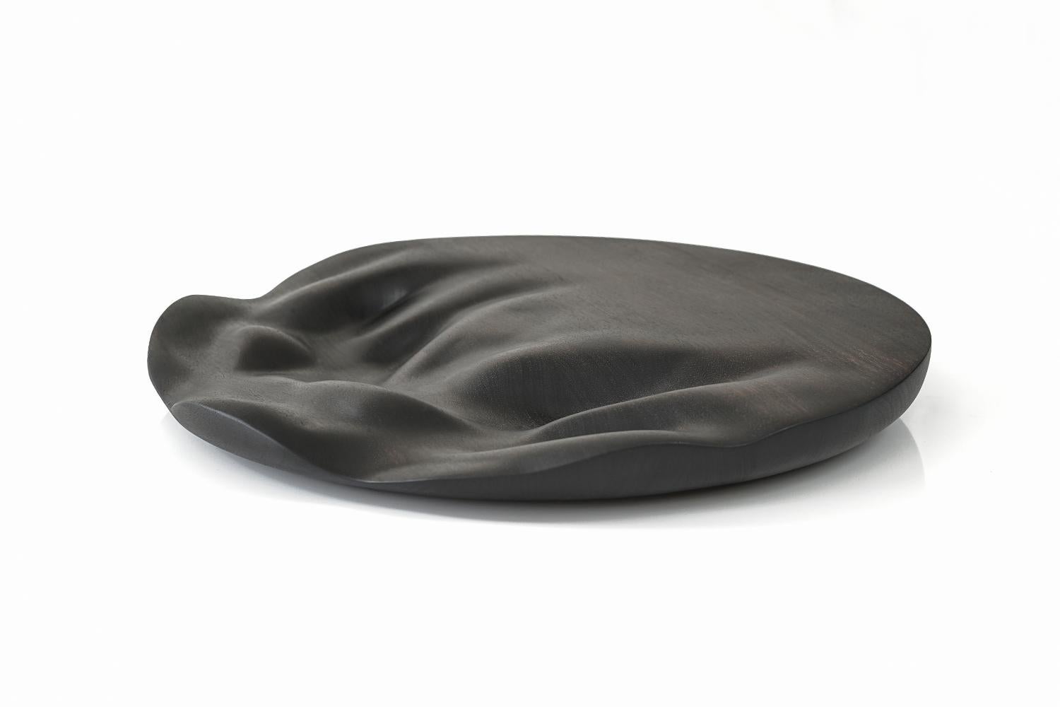 Large flow round contemporary ebonized serving board by Vincent Pocsik

Carved walnut cutting board with ebonized finish.

Natural food safe oil and wax finish. 

Vincent Pocsik finds the balance between old and new fabrication techniques