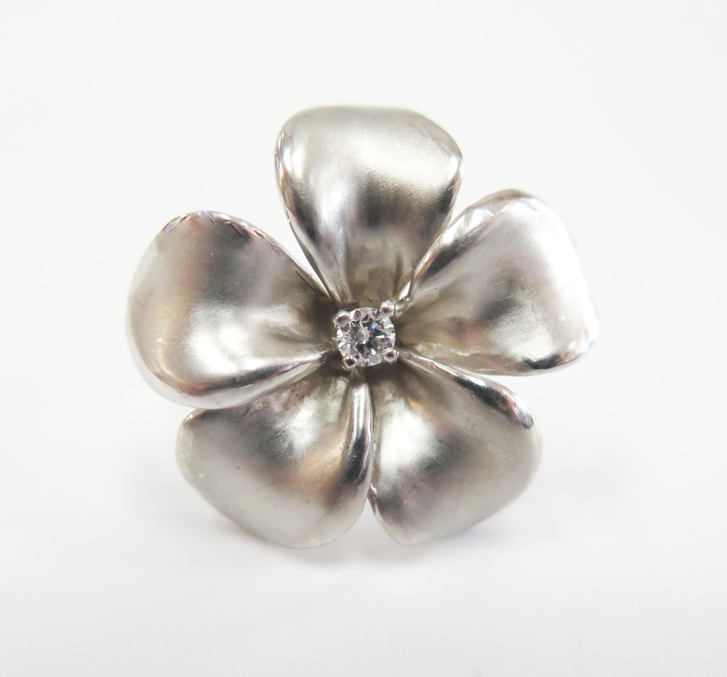 It's always springtime when you're wearing this sunny flower statement ring. A sparkling center diamond of 0.10 Carat finishes the look. You won't need another piece of jewelry when you wear this pretty ring!

14 karat white gold
Size 7 1/2 - easily