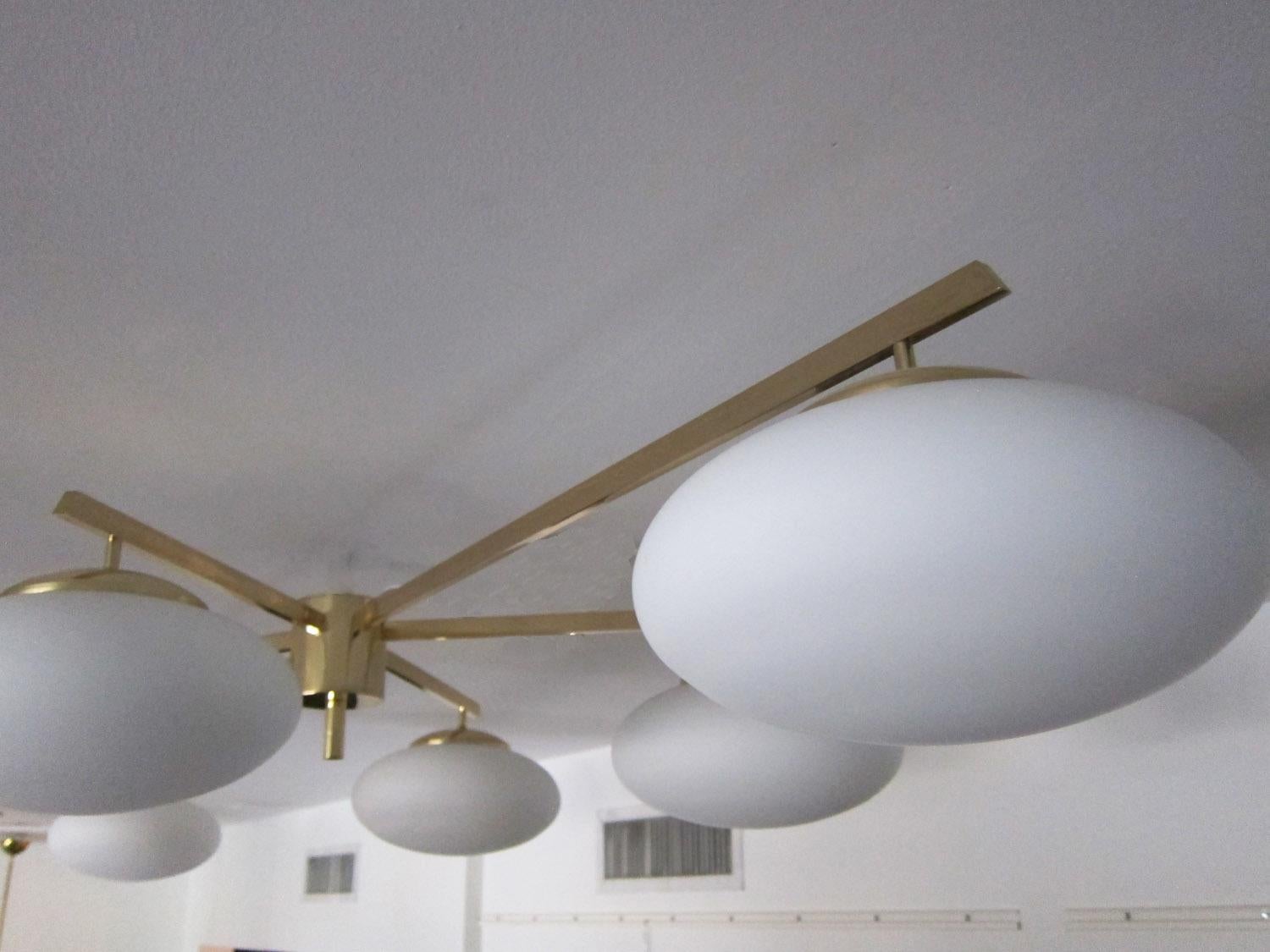 Large contemporary Italian flush mount ceiling fixture in polished brass with six opaline oblong globes
Stunning geometrical design from all angles, 
Available to view in situ at our showroom in Miami
Ready to ship
Fixture should be checked by a