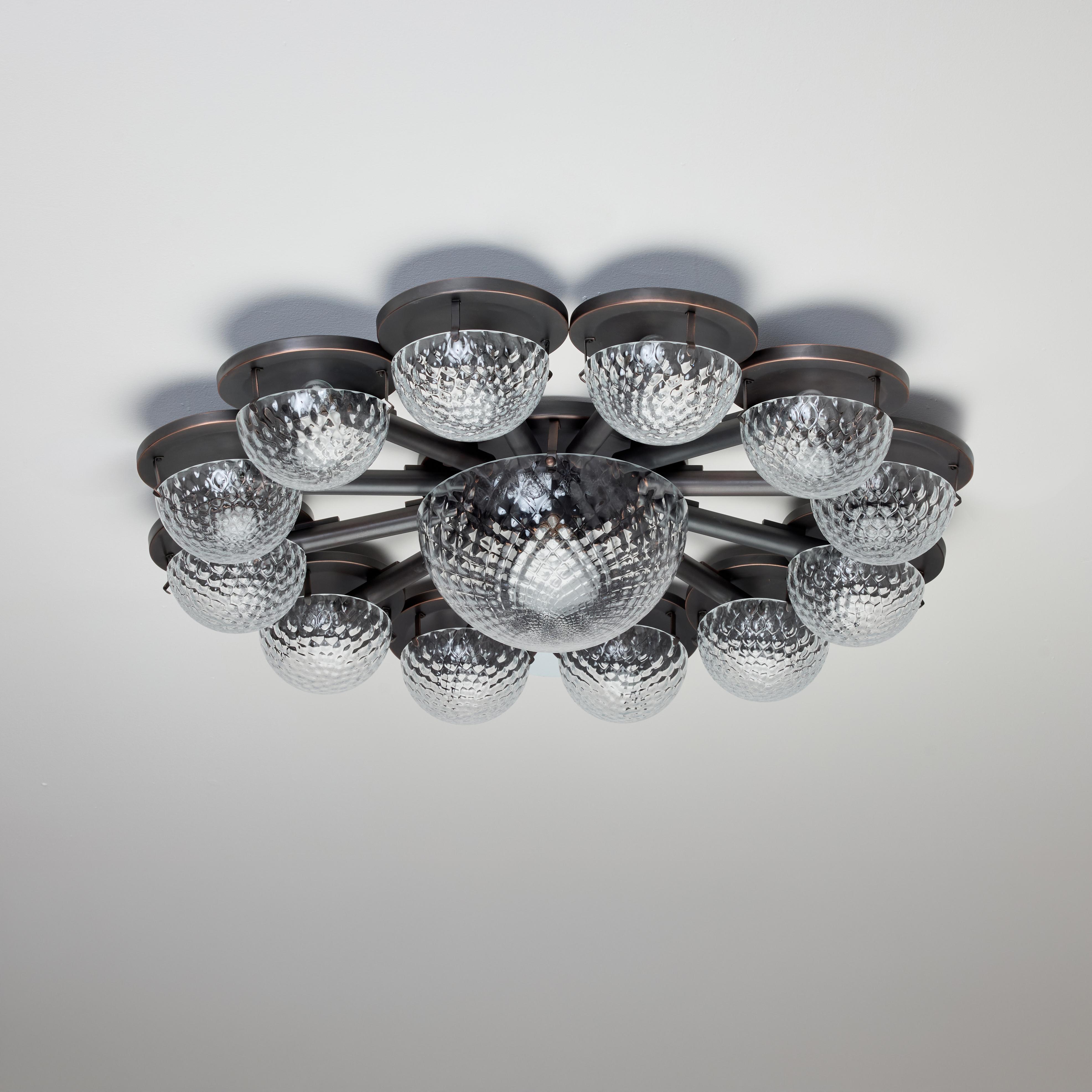 Large Flush Mount by Lumi (Italy, 1960s)

Bronze plated extra large flush mount with gorgeous pressed glass diffusers. Twelve outer glass bowls and a central glass bowl. Each bowl receives a medium base socket type. We recommend 25w-40w max bulbs or