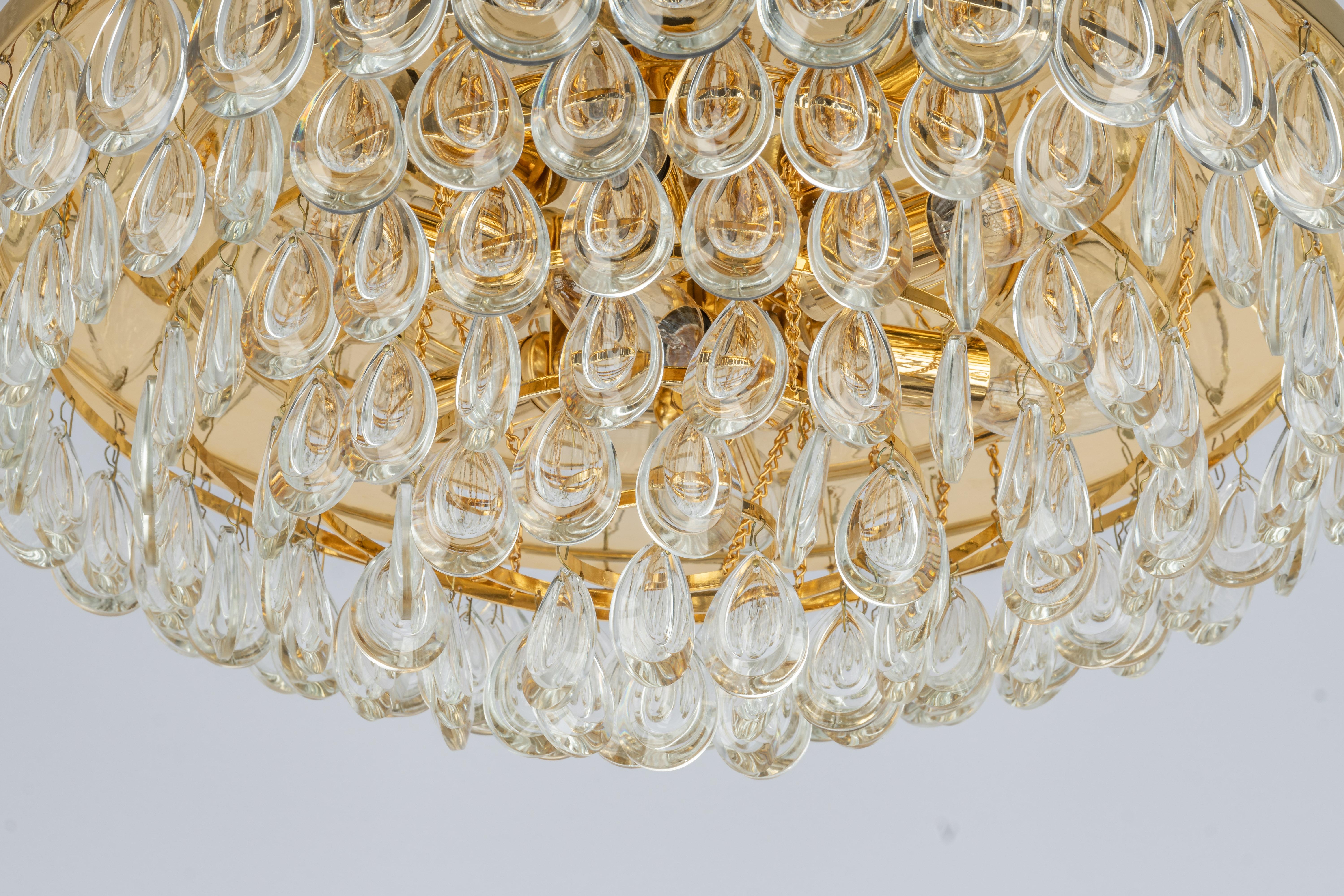 A wonderful and high-quality gilded chandelier or pendant light fixture by Palwa , Germany, 1970s.
It is made of a 24-carat gold-plated brass frame decorated with individual 