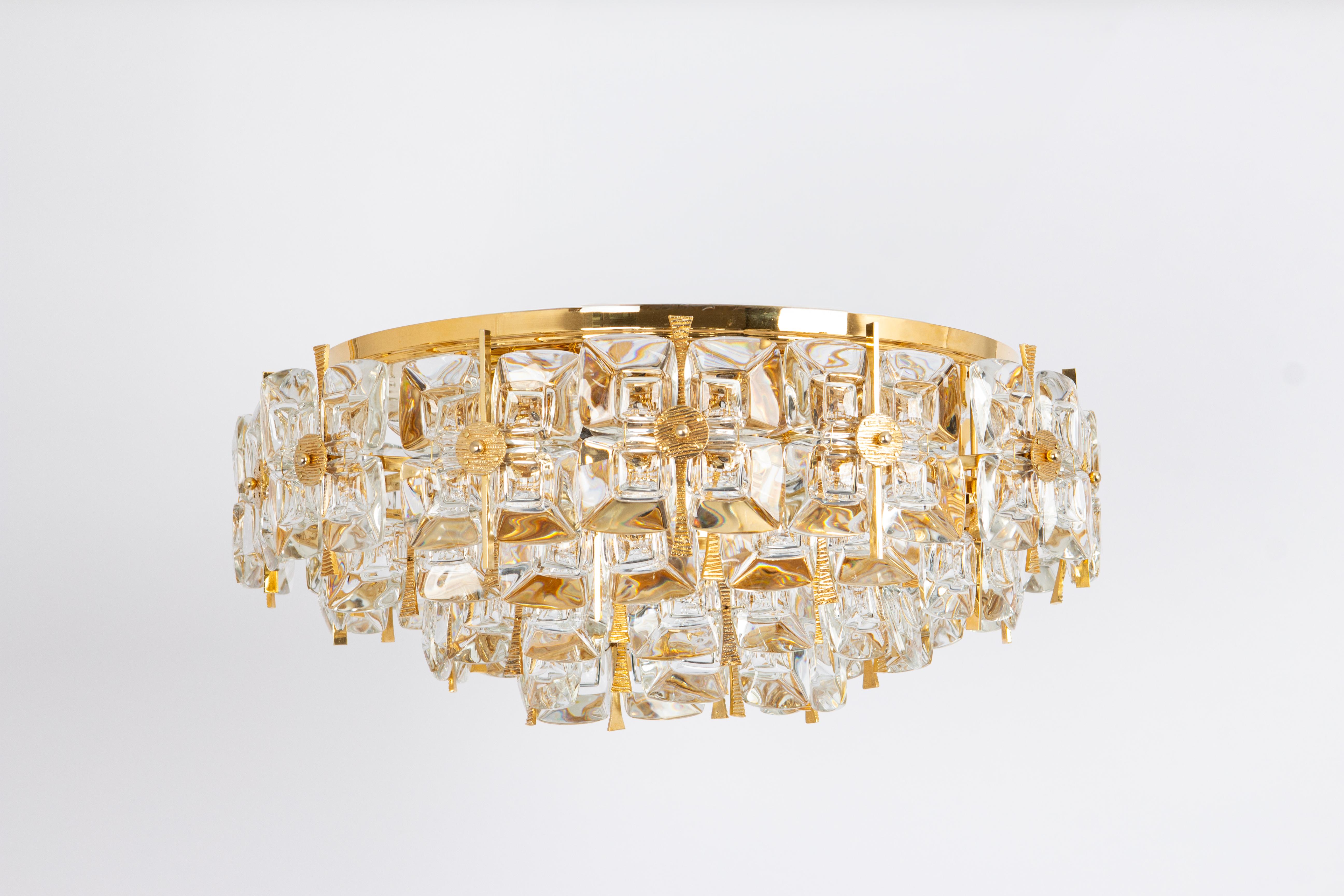 A wonderful and high-quality gilded chandelier or pendant light fixture by Palwa , Germany, 1970s.
It is made of a 24-carat gold-plated brass frame decorated with individual 