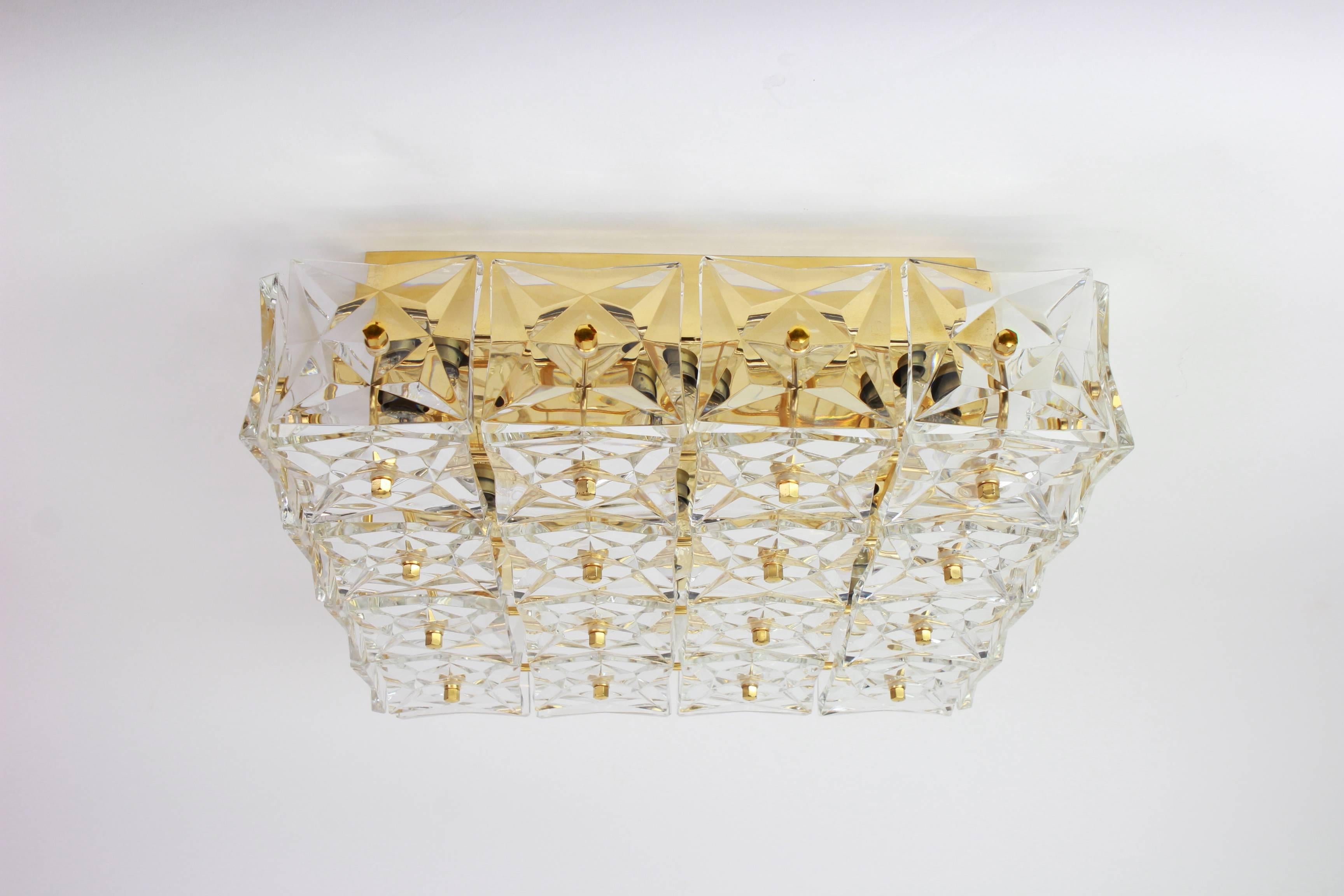 A stunning light fixture by Kinkeldey, Germany, manufactured in circa 1970-1979. A handmade and high quality piece. The fixture is made of gilded brass and with lots of facetted crystal glass elements.

High quality and in very good condition.
