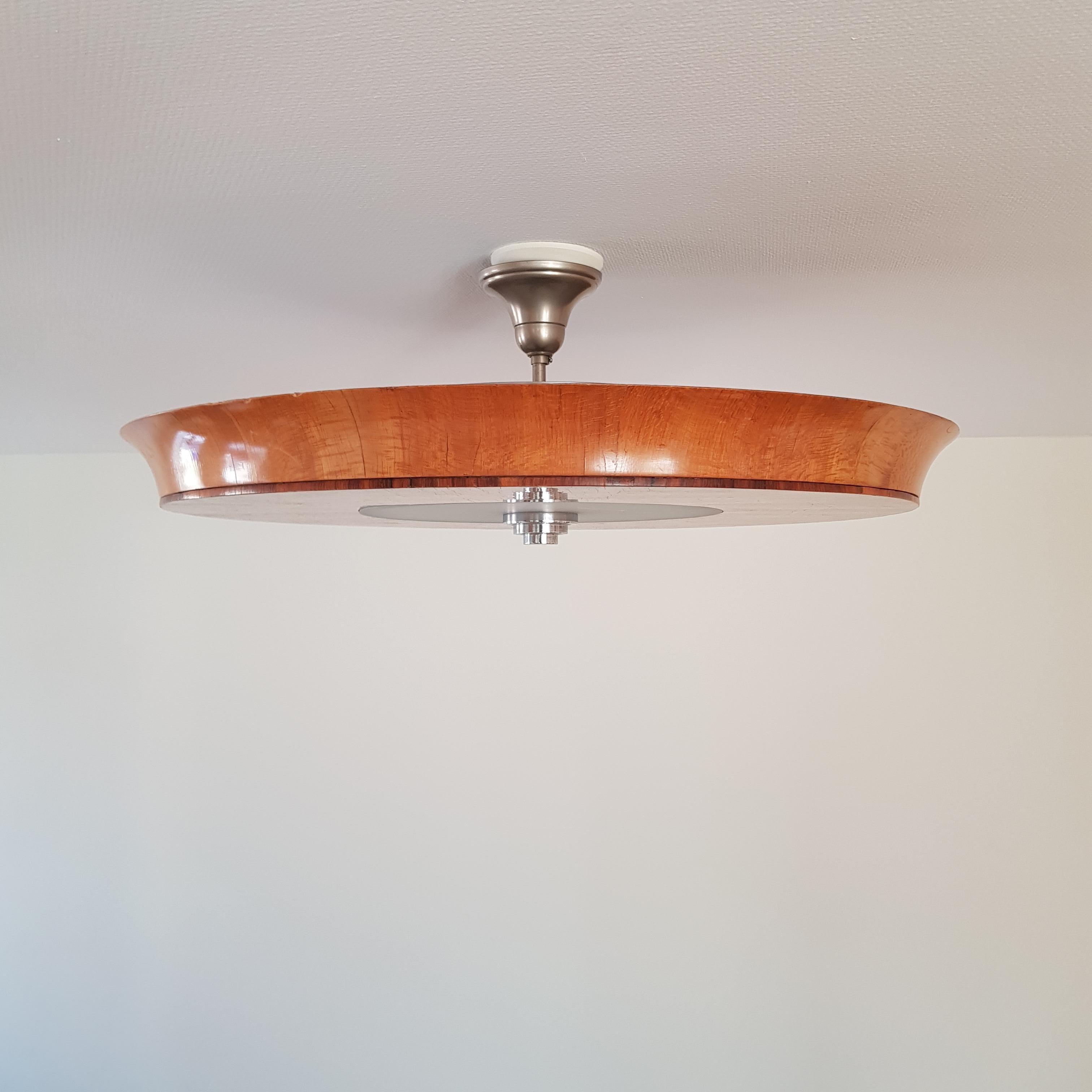 Elegant Swedish Grace / Art Deco hanging flush mount ceiling lamp from the 1930s. Most likely designed by Birger Ekman for Mjölby Intarsia. The piece features an intricatefloral inlay along the face with an unusual rounded beveling at rim. Incised