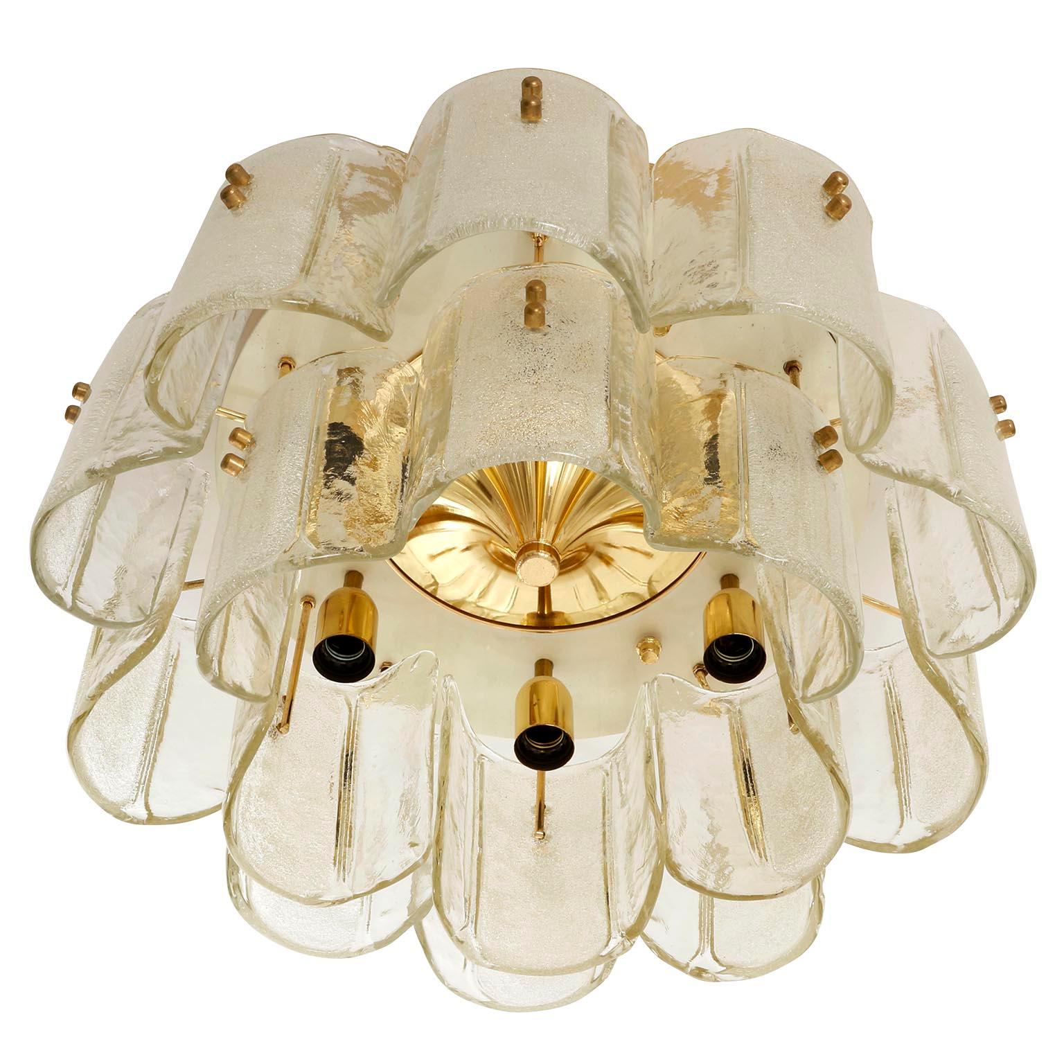 An extra large flushmount light manufactured in midcentury, circa 1970.
A polished brass and white enameled backplate holds 16 curved art glass elements with brass bolts.
The lamp takes six medium or standard screw base bulbs up to max. 60W per bulb