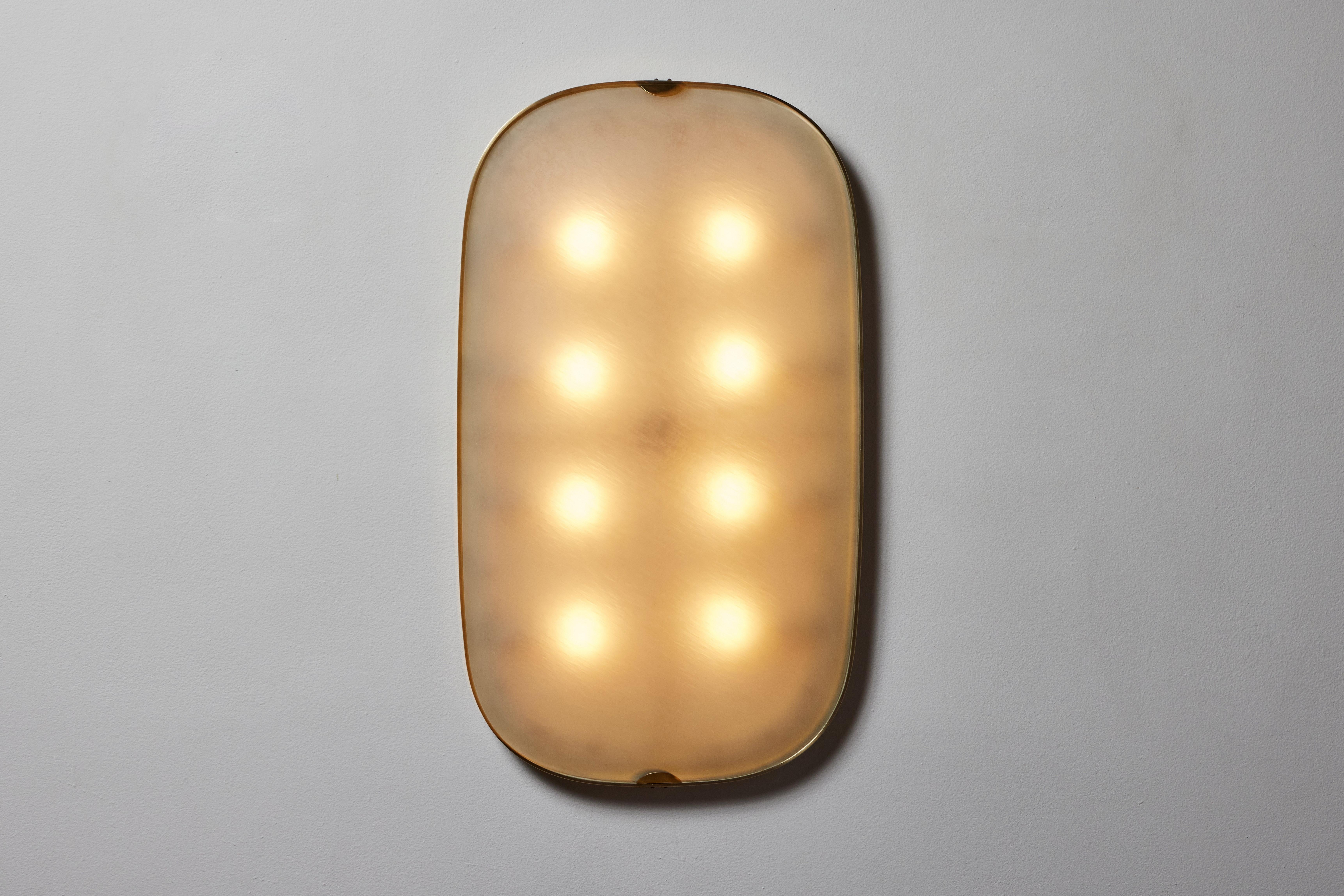 Large flush mount wall /ceiling light by Fontana Arte. Manufactured in Italy, circa 1950's. Textured glass, brass. enameled metal. Rewired for U.S. standards. We recommend eight E26 25w maximum bulbs. Bulbs provided as a one time courtesy.