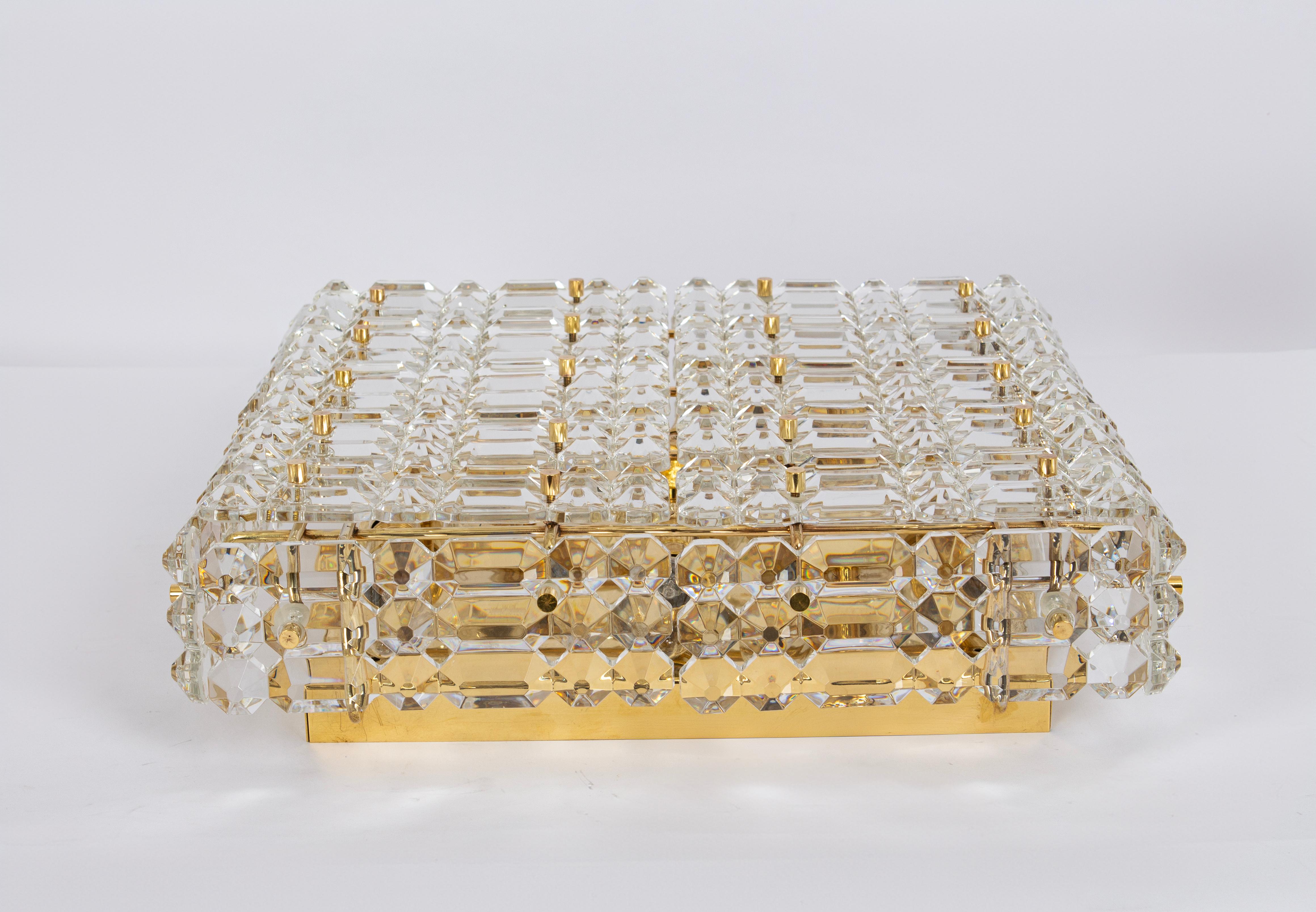 Wonderful light fixture in style of Kinkeldey, Germany, manufactured in circa 1960-1969. The fixture is made of a brass frame with many facetted crystal glass elements.
Measures: Width 16.9 in /43 cm
Height 5.5 in / 14 cm

Sockets: 8 x E14 small